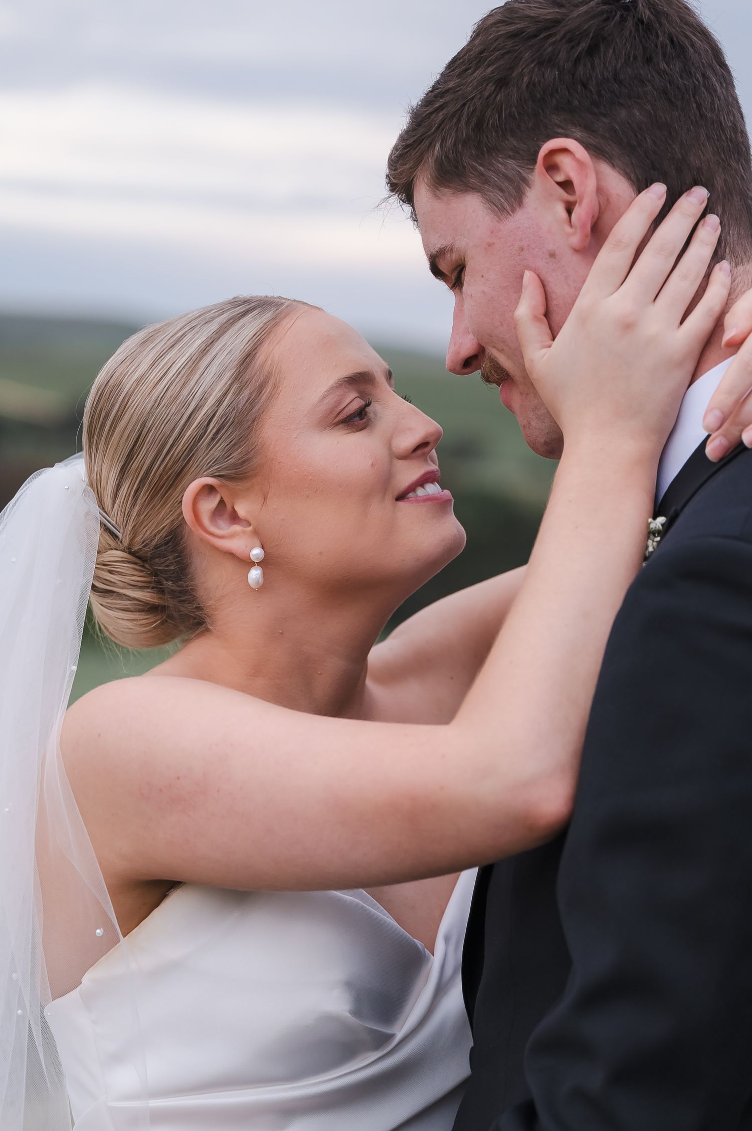 A romantic moment between newlyweds as they share an intimate embrace during their outdoor wedding photoshoot.