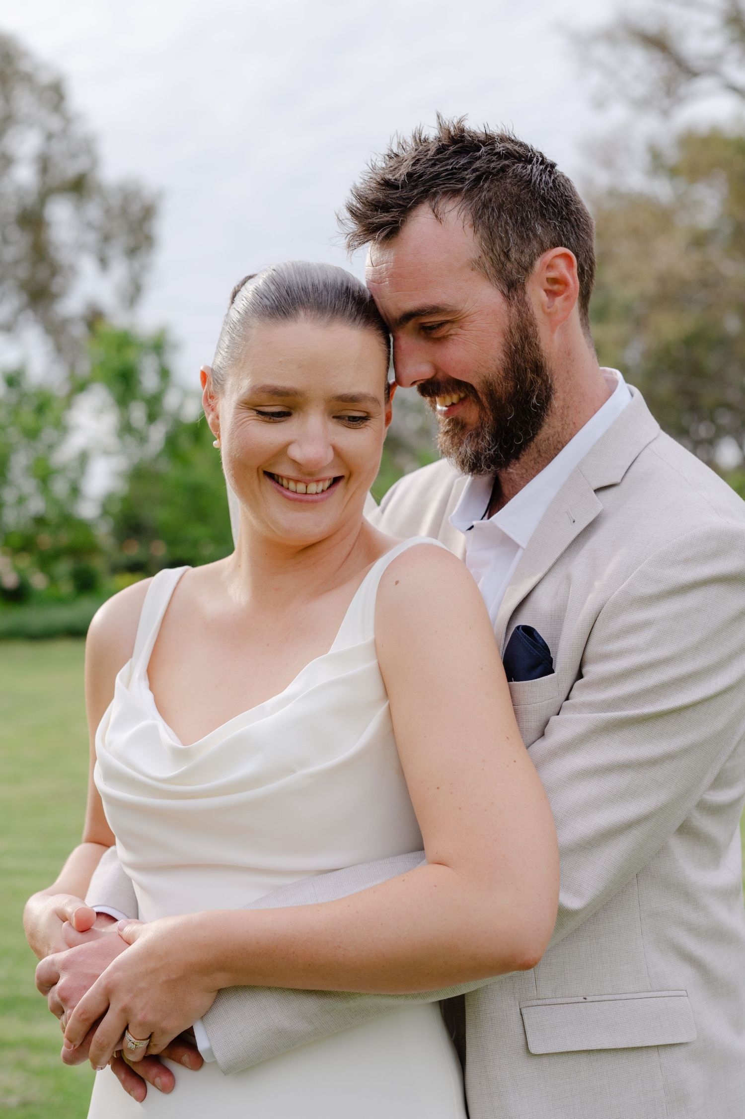 A couple shares intimate moments in a series of candid wedding photos showing joyful embraces and laughter.