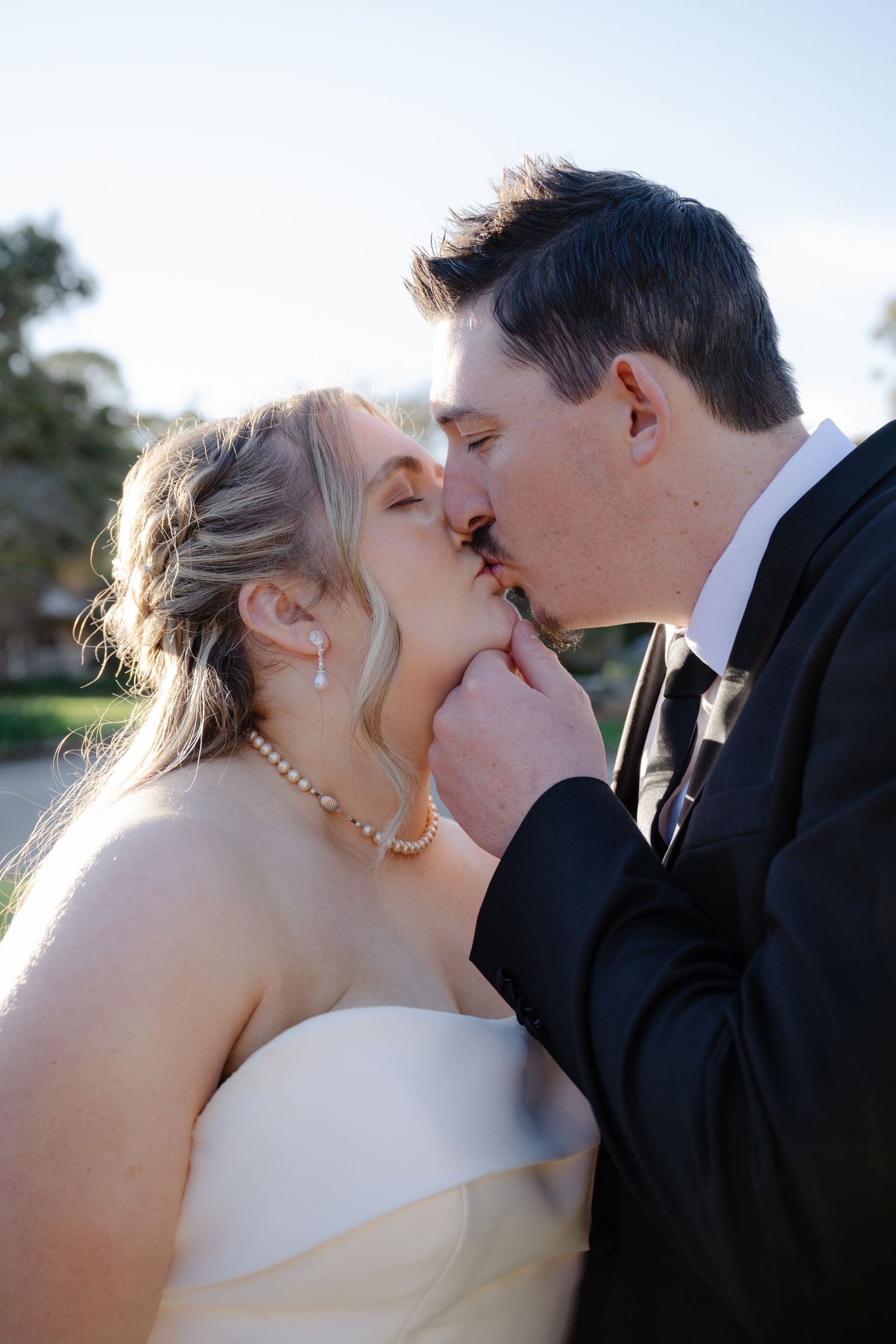 A romantic wedding couple shares a tender kiss during sunset, captured in a series of close-up photos.