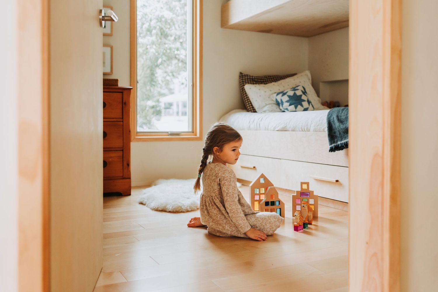 Four connected photos show a minimalist beige interior space with a sofa, furniture, and natural lighting through windows.