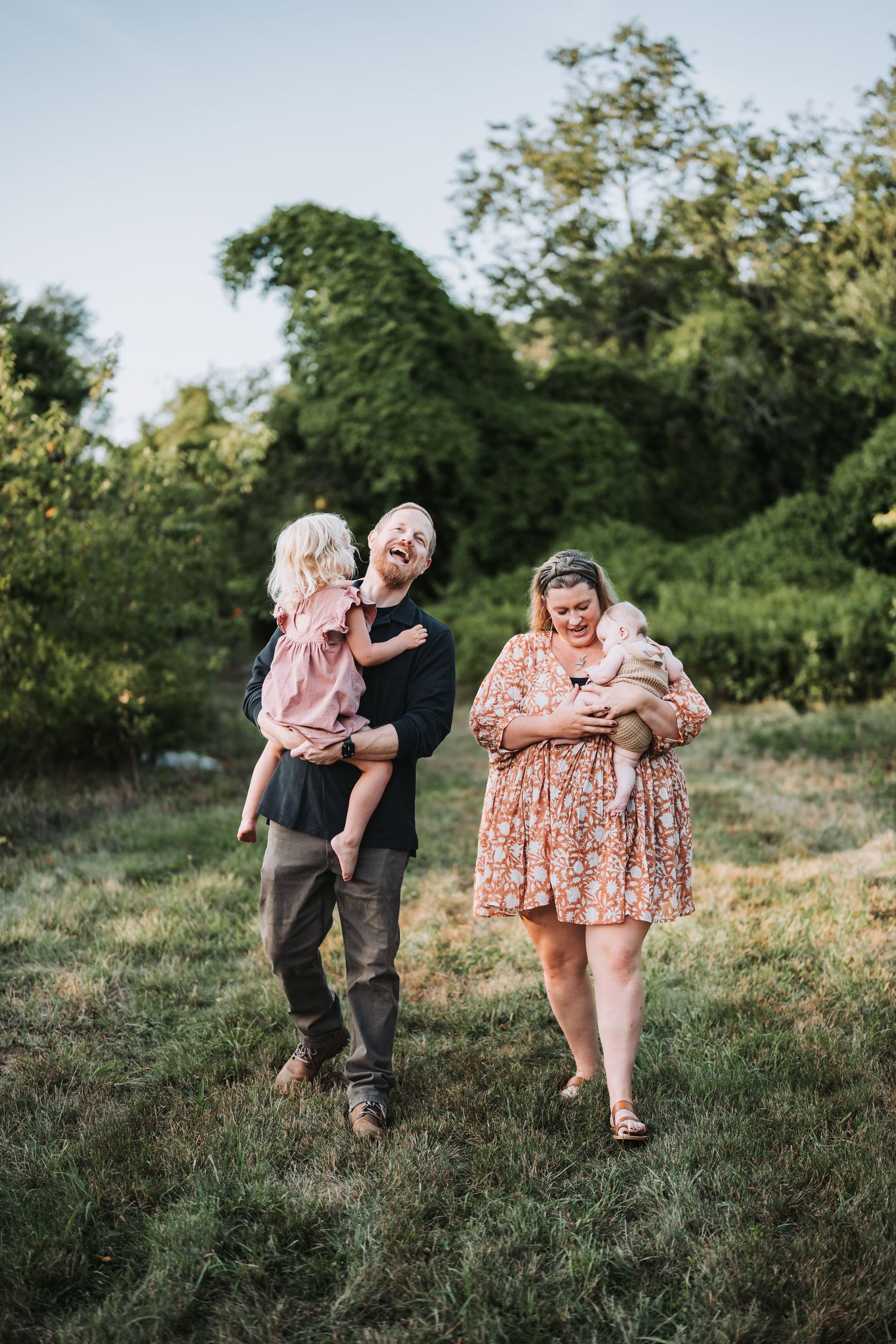A joyful sequence of candid moments captured between family members playing in a grassy outdoor setting.
