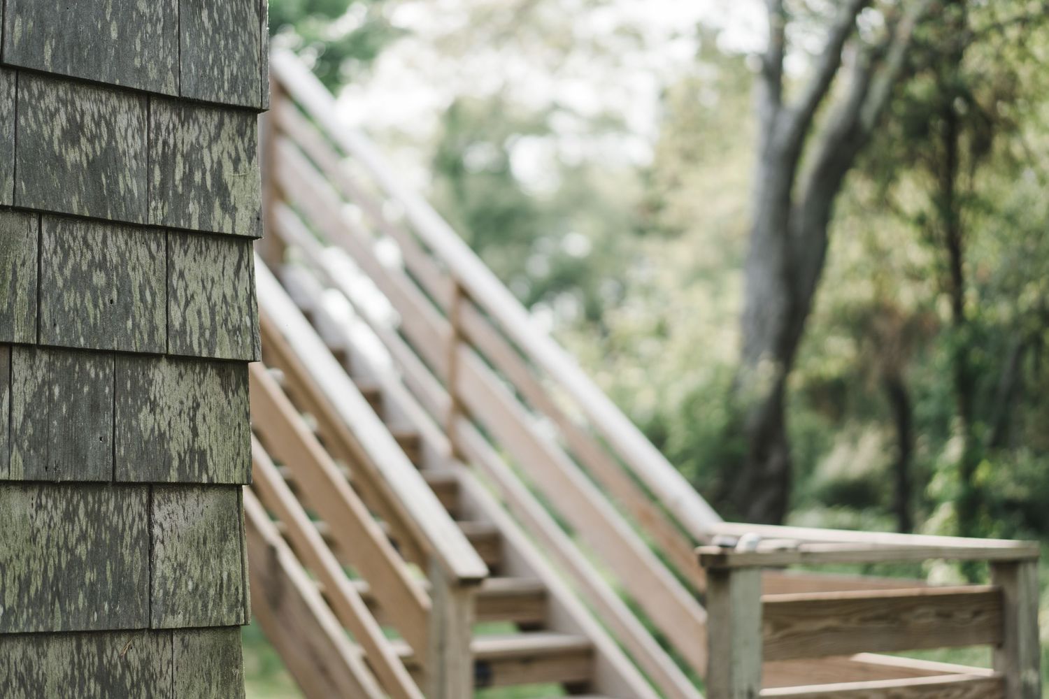 Rustic wood cabin planks with vertical siding and angular roof rafters create geometric patterns in natural lighting.