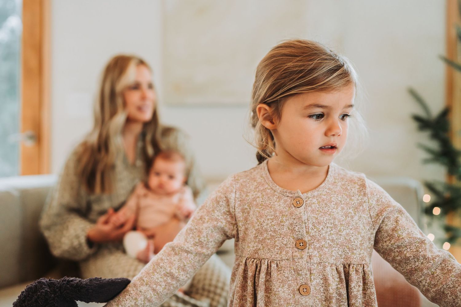 Family spending quality time together in a cozy living room with neutral tones and natural light.