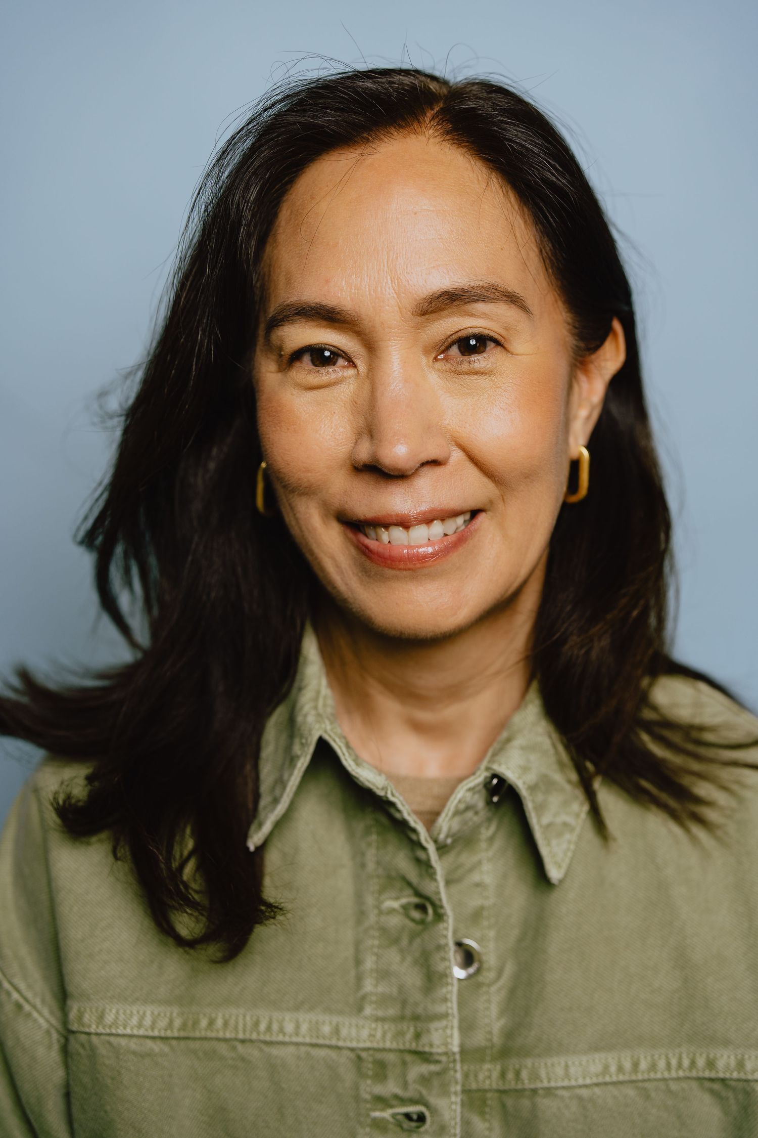 A sequence of five headshots showing someone in a casual olive green collared shirt against a light background.
