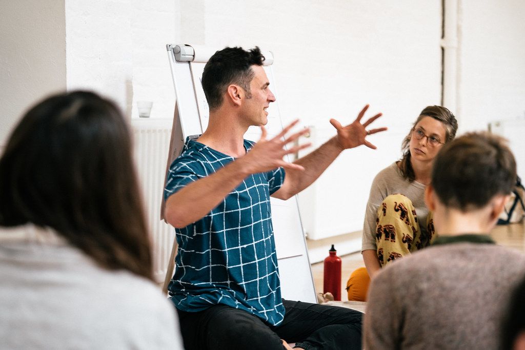 A group of people engaged in an animated discussion during a business meeting or workshop.