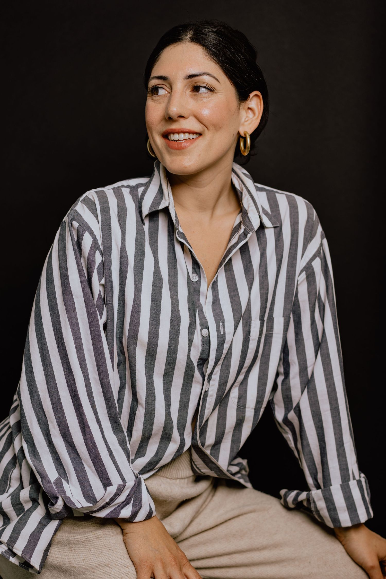 A series of candid shots showing someone in a gray and white striped button-down shirt against a dark background.
