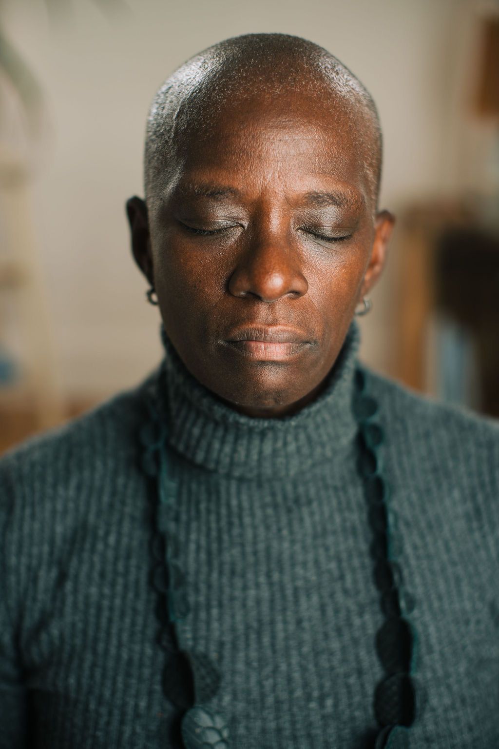 A series of close-up photos showing a person in a green turtleneck sweater with eyes closed and a gentle smile.