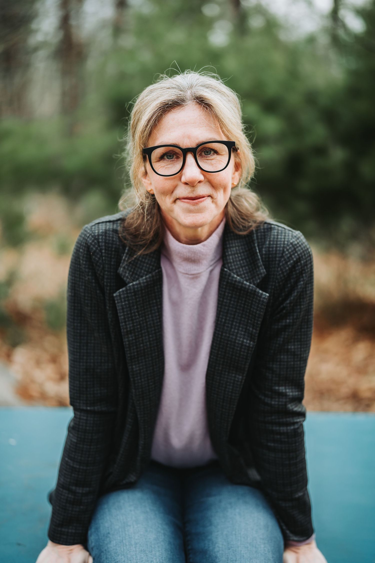 A series of six similar portraits showing someone in a gray blazer and lavender sweater against a blurred outdoor background.