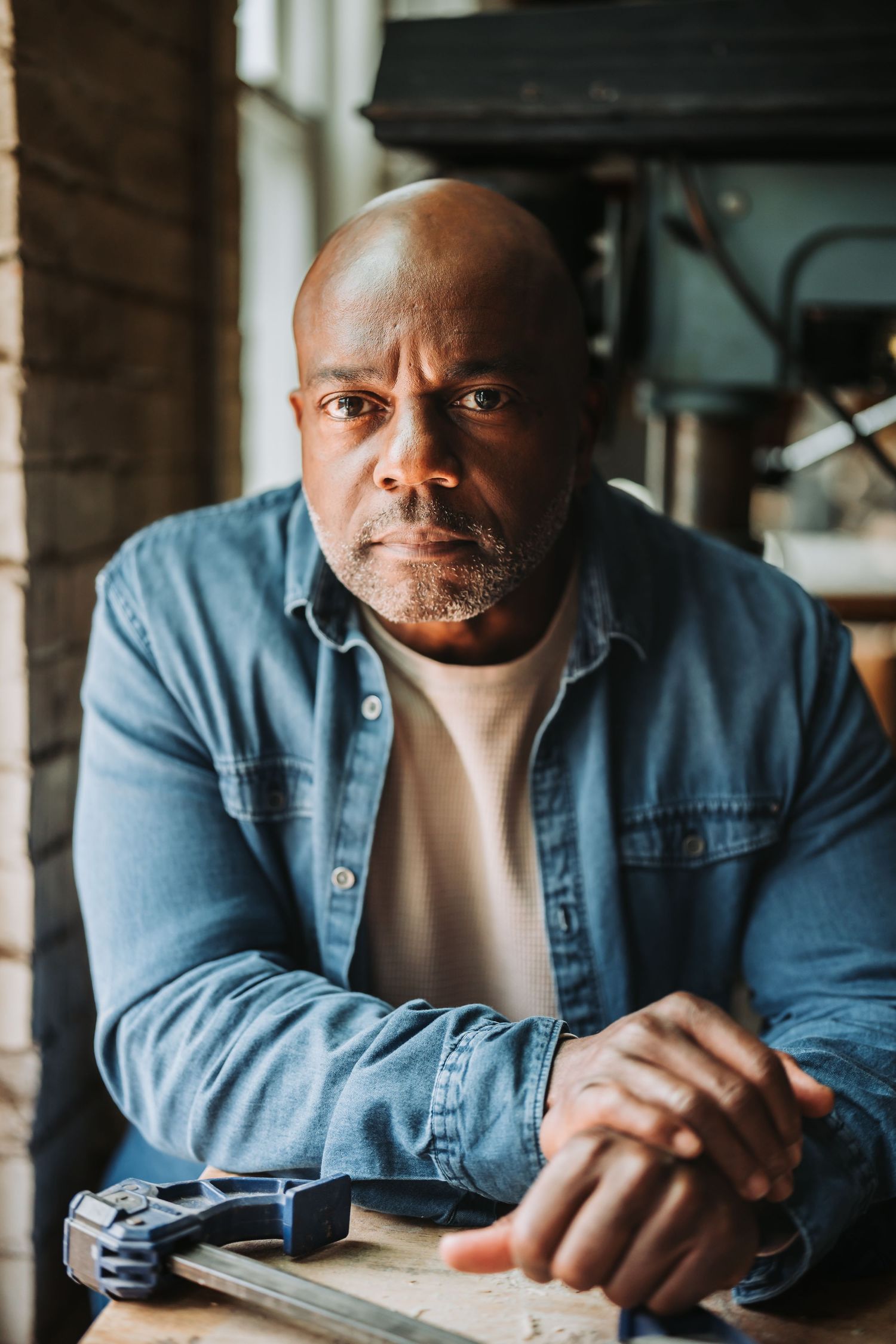 A triptych portrait of a person in denim shirt leaning on a table, shown from three different angles.