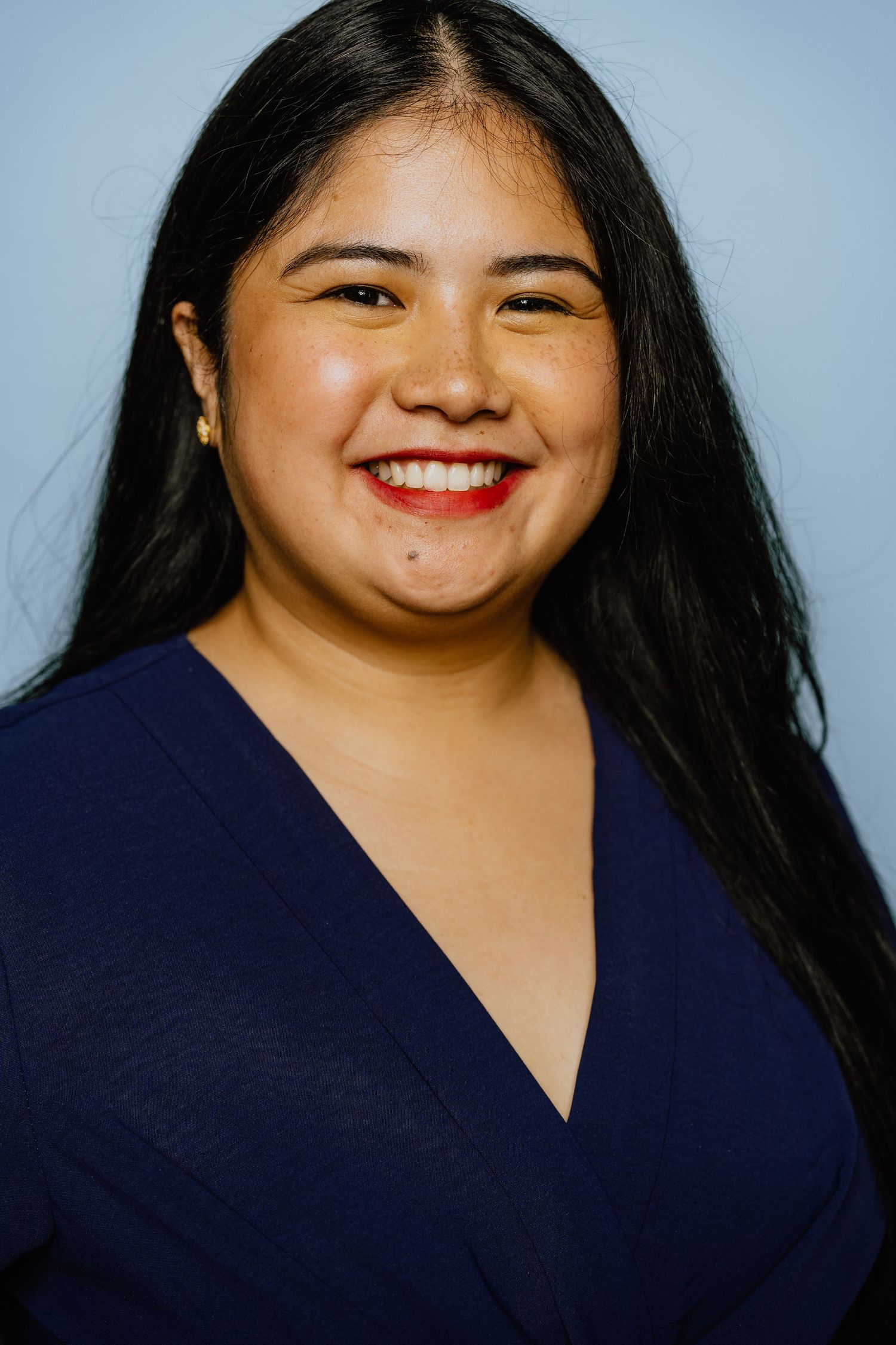 A series of six headshots showing joyful expressions and genuine smiles against a light background.