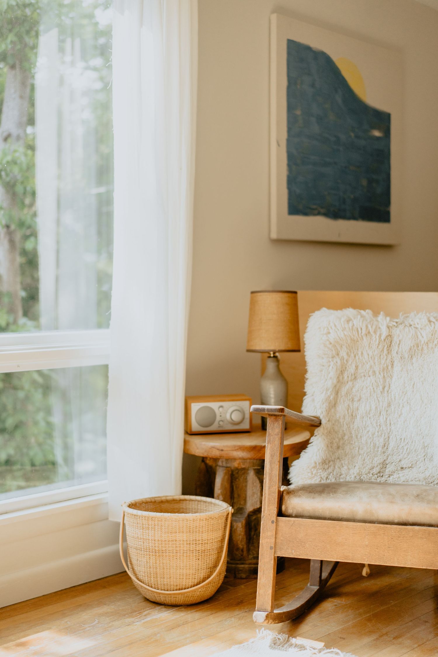 Cozy coastal-inspired living room corner with woven baskets and white textiles.