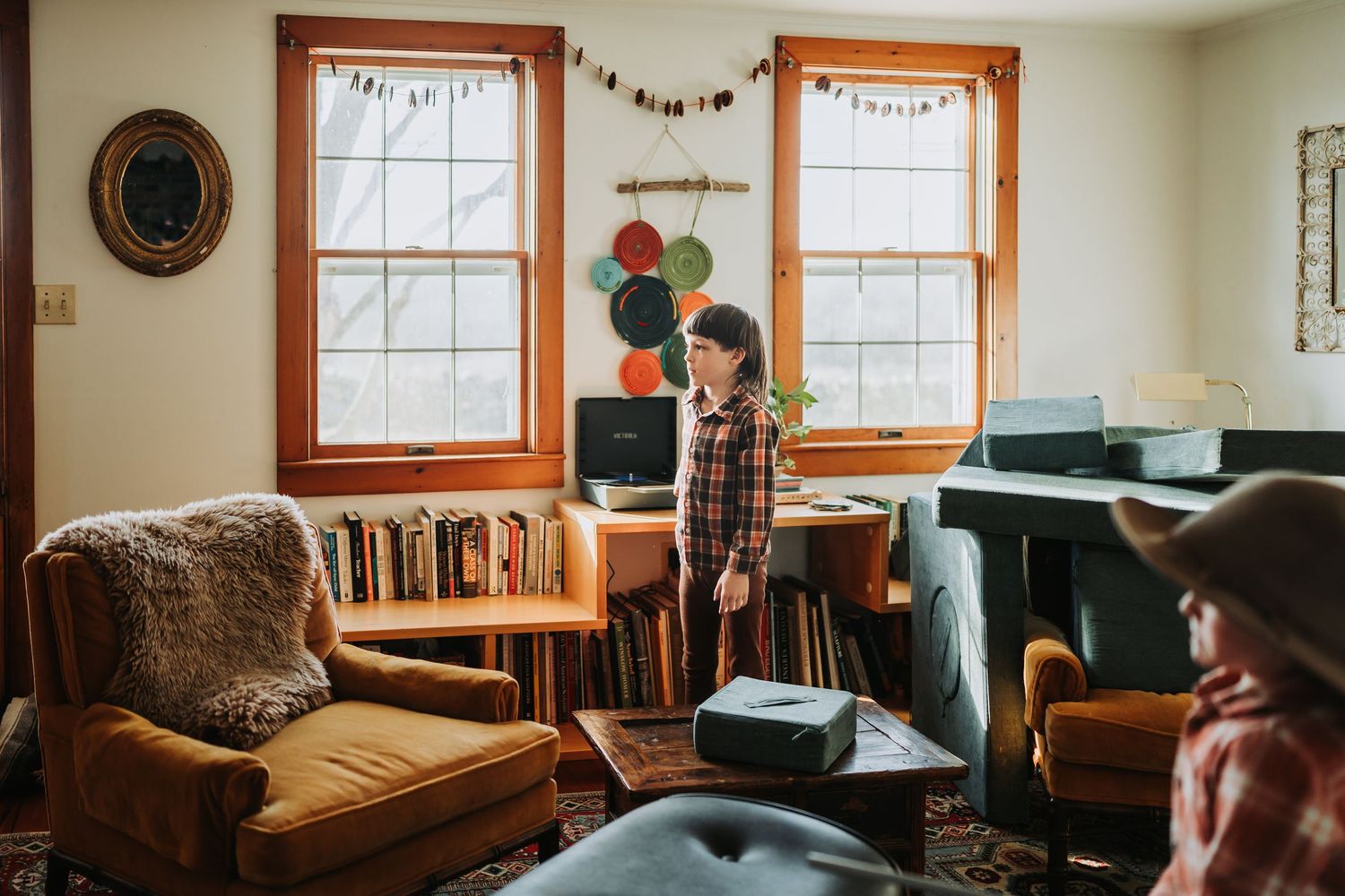 Cozy interior of a rustic room with wooden window frames and decorative garlands strung across the walls.