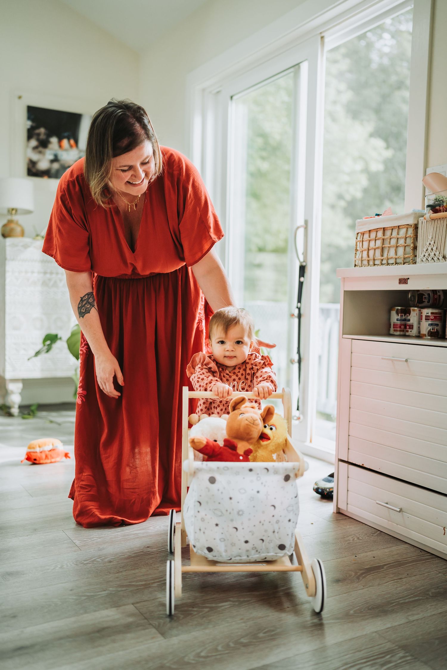 A baby in a polka dot high chair is captured in a series of playful moments with someone in a red dress.