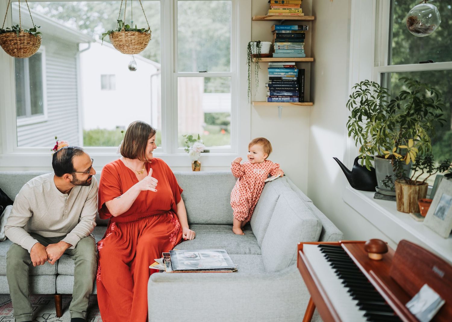 A series of candid moments show a family playing piano, reading books, and spending quality time together at home.