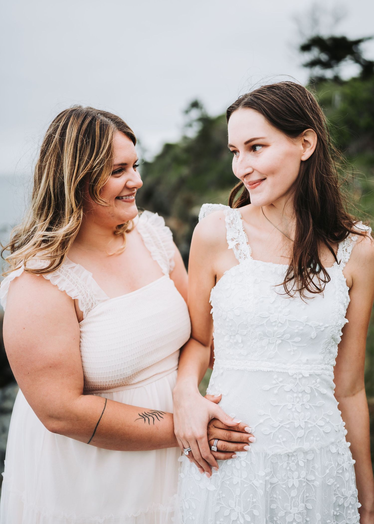 A series of candid moments between two people in white dresses laughing and embracing outdoors.
