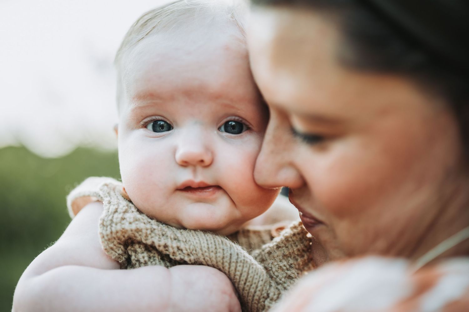 A tender moment between parent and baby captured through a series of intimate outdoor portraits.