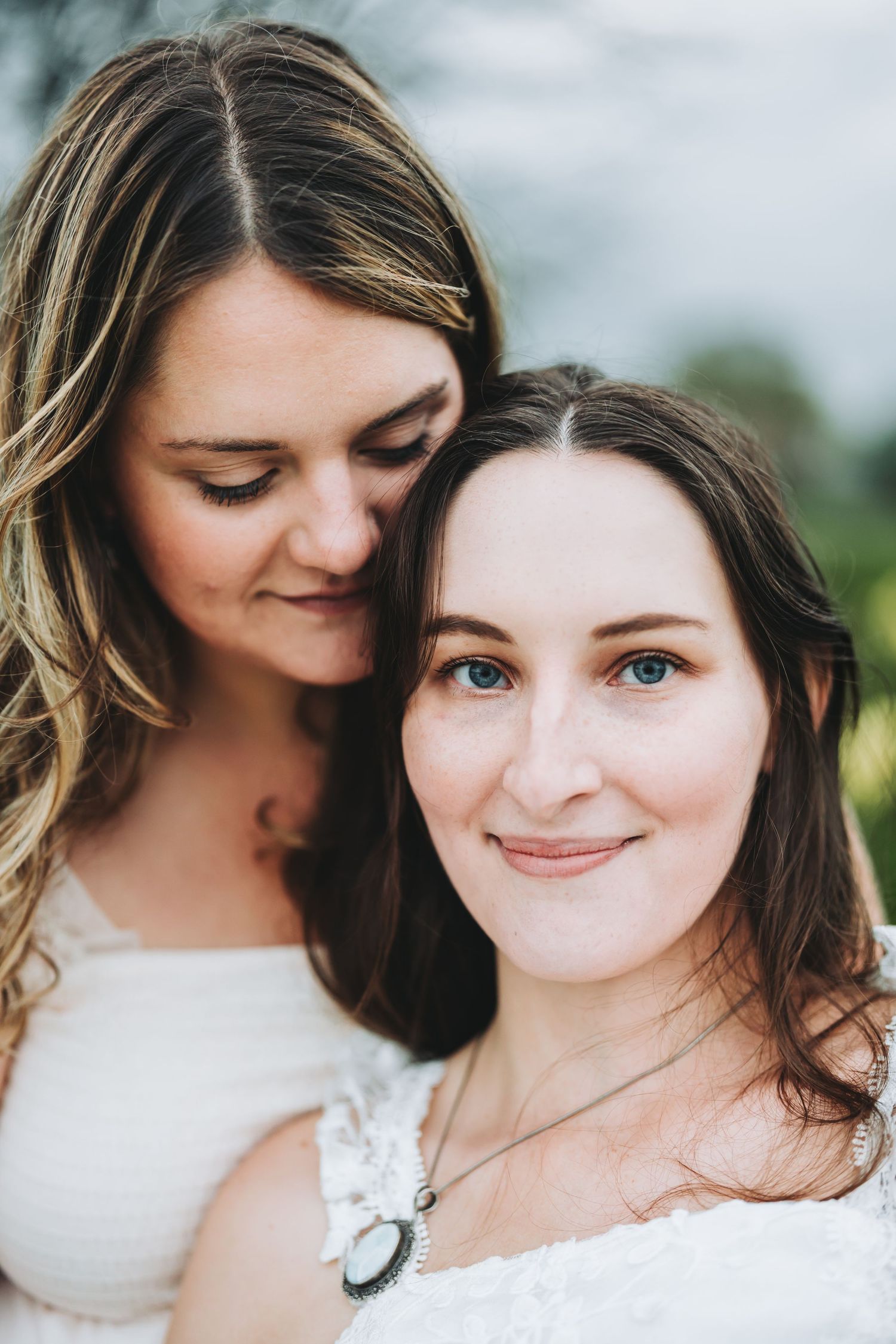 Five intimate close-up photos showing tender moments between two people in white dresses.