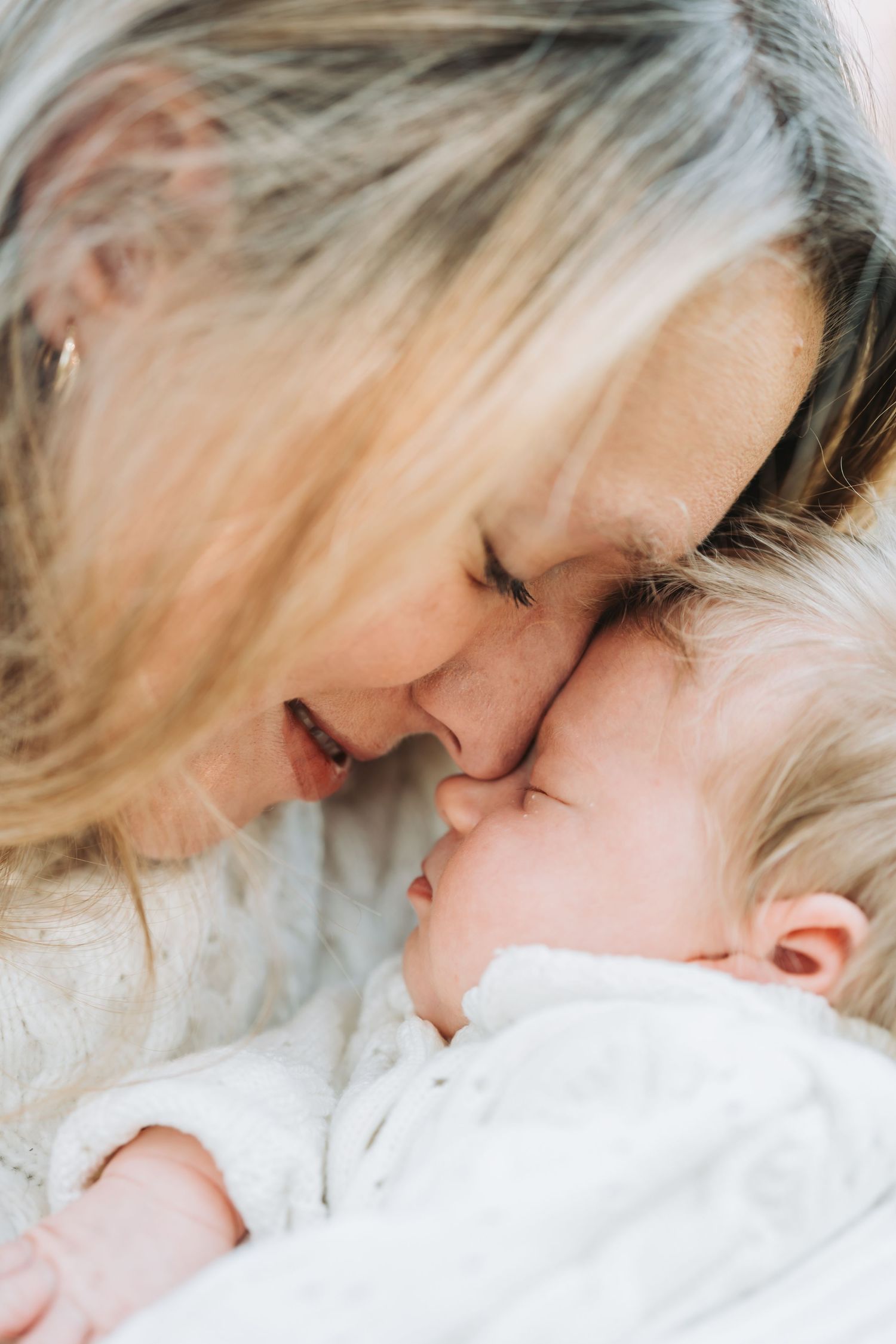 Intimate close-up moment of gentle affection in soft natural lighting.