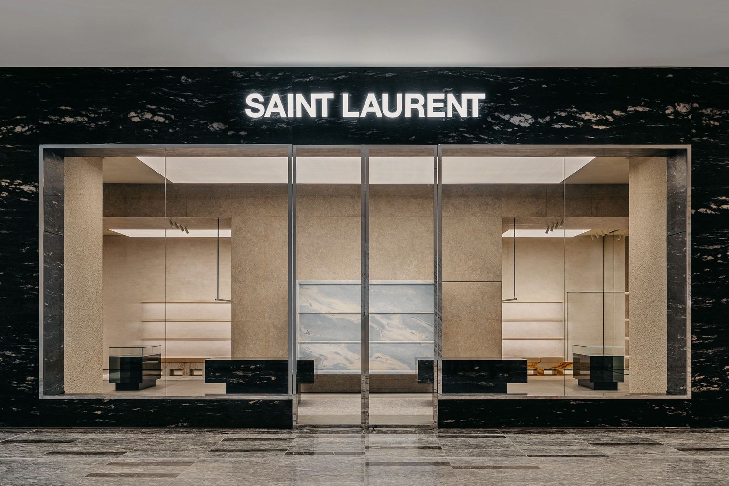Saint Laurent luxury retail storefront with sleek black marble exterior and minimalist window displays.