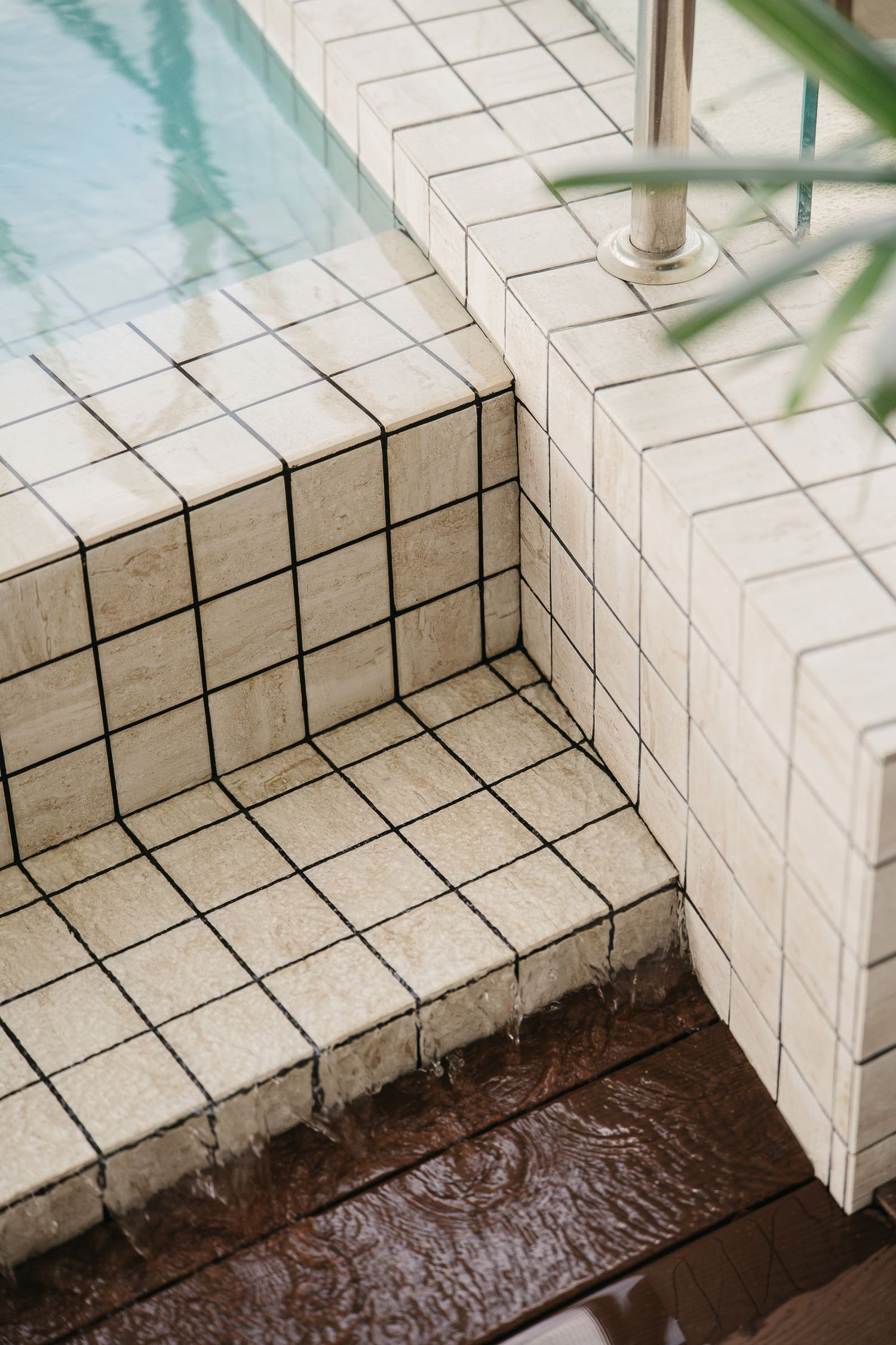Five sequential images showing water damage and flooding seeping into a tiled bathroom corner near baseboards.