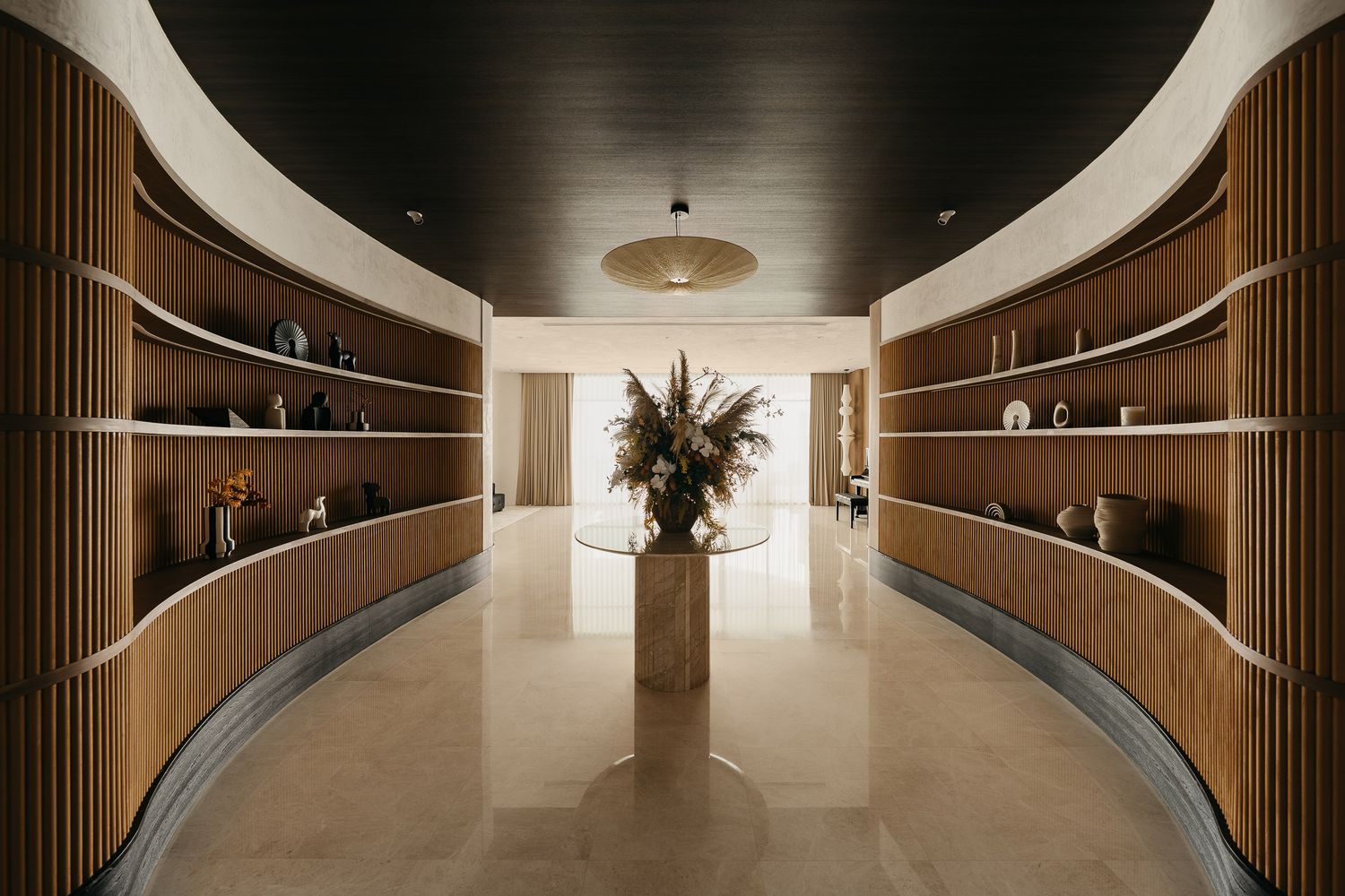 Modern office corridor with curved wooden walls, recessed lighting, and sleek minimalist design features a contemporary aesthetic.