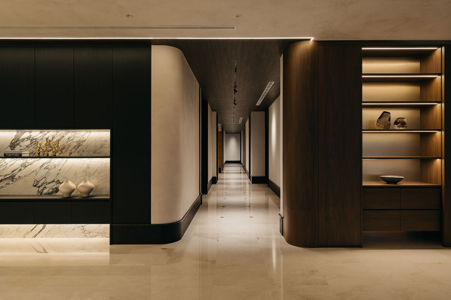 Minimalist art gallery interior with illuminated display shelves and dramatic lighting along a sleek corridor.