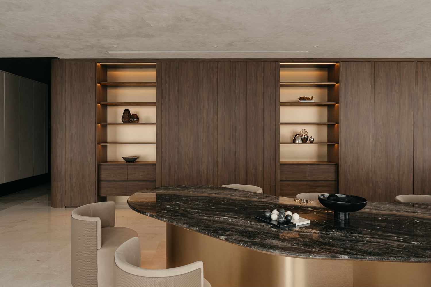 Modern minimalist interior design with dark marble countertops and wooden paneling in a luxurious space.