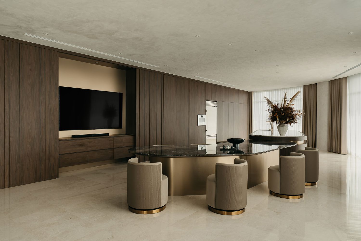 Modern minimalist interior design with dark wood panels and curved seating in a luxurious open-plan space.