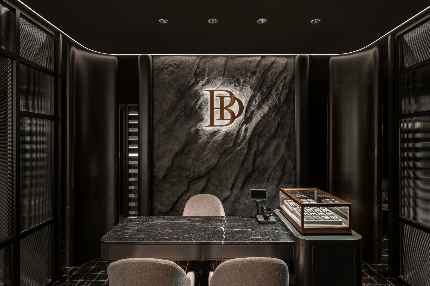 Modern luxury hotel lobby with dark marble walls, geometric lighting fixtures and sleek minimalist design elements.