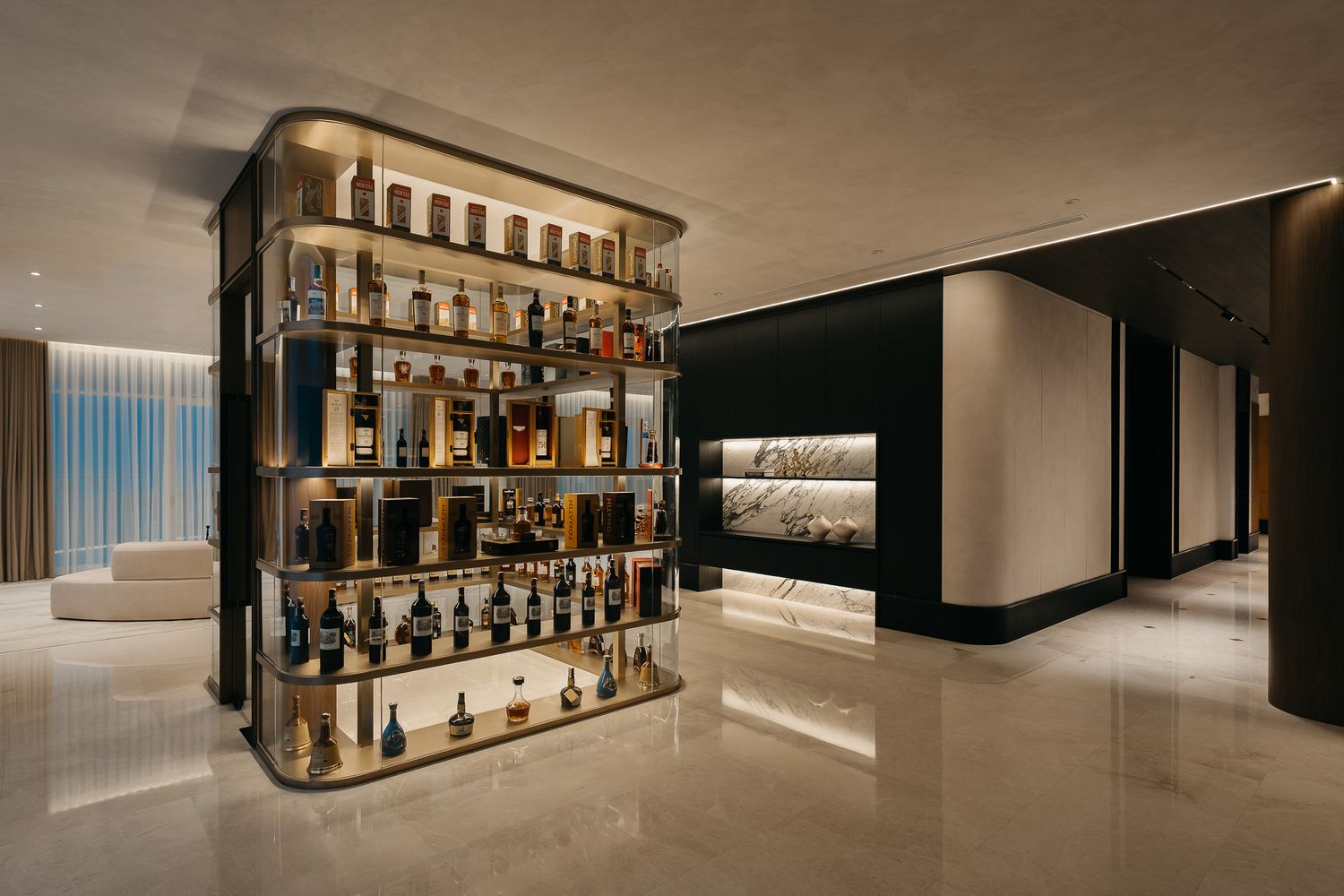 Modern luxury bar interior with illuminated shelving displaying bottles against a sleek minimalist design background.