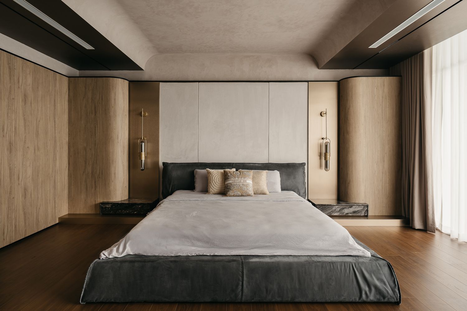 Modern minimalist bedroom with wood paneling, grey bedding, and natural lighting showcases sleek contemporary design.