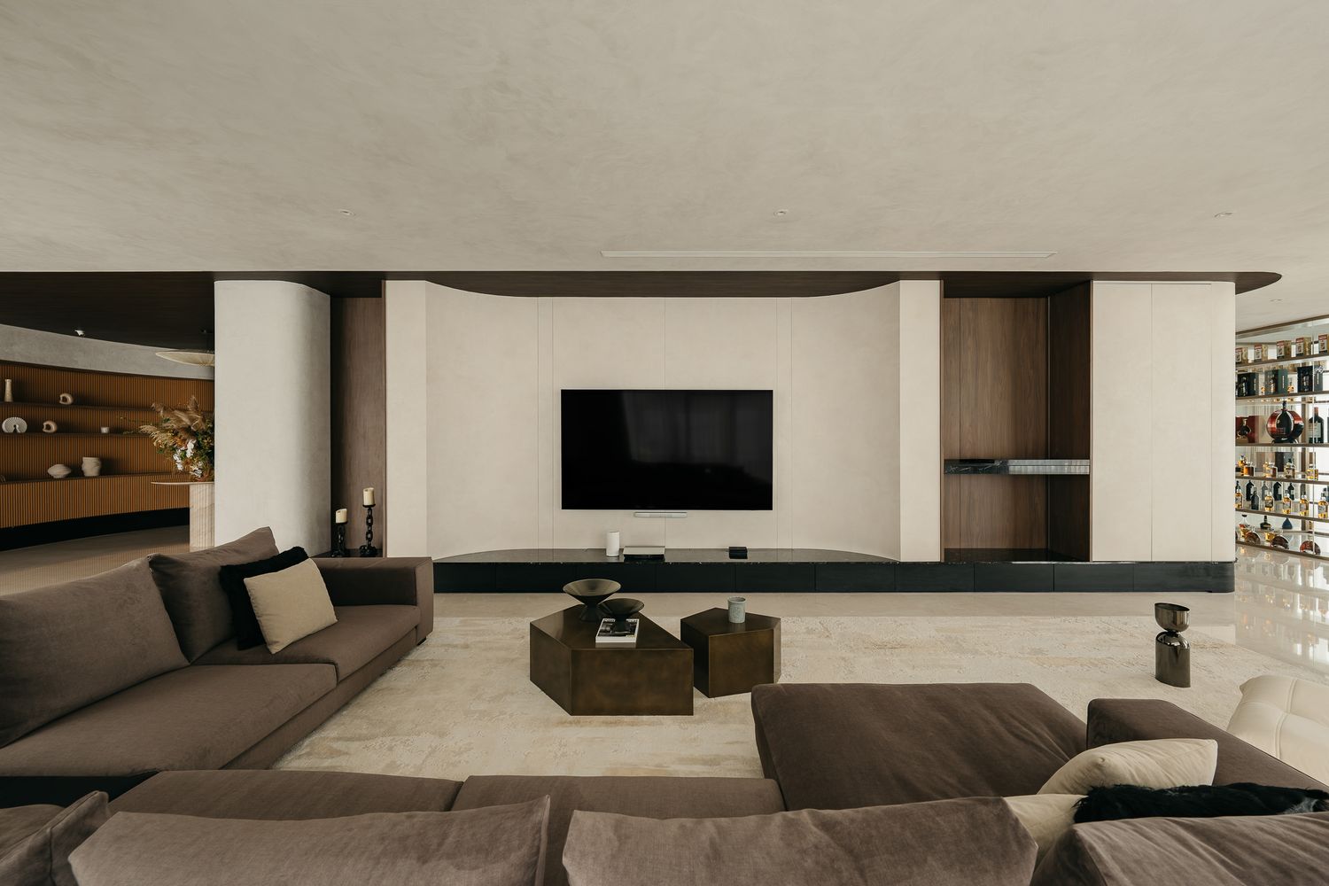 Modern minimalist interior design featuring sleek white walls and built-in shelving in an open concept living space.