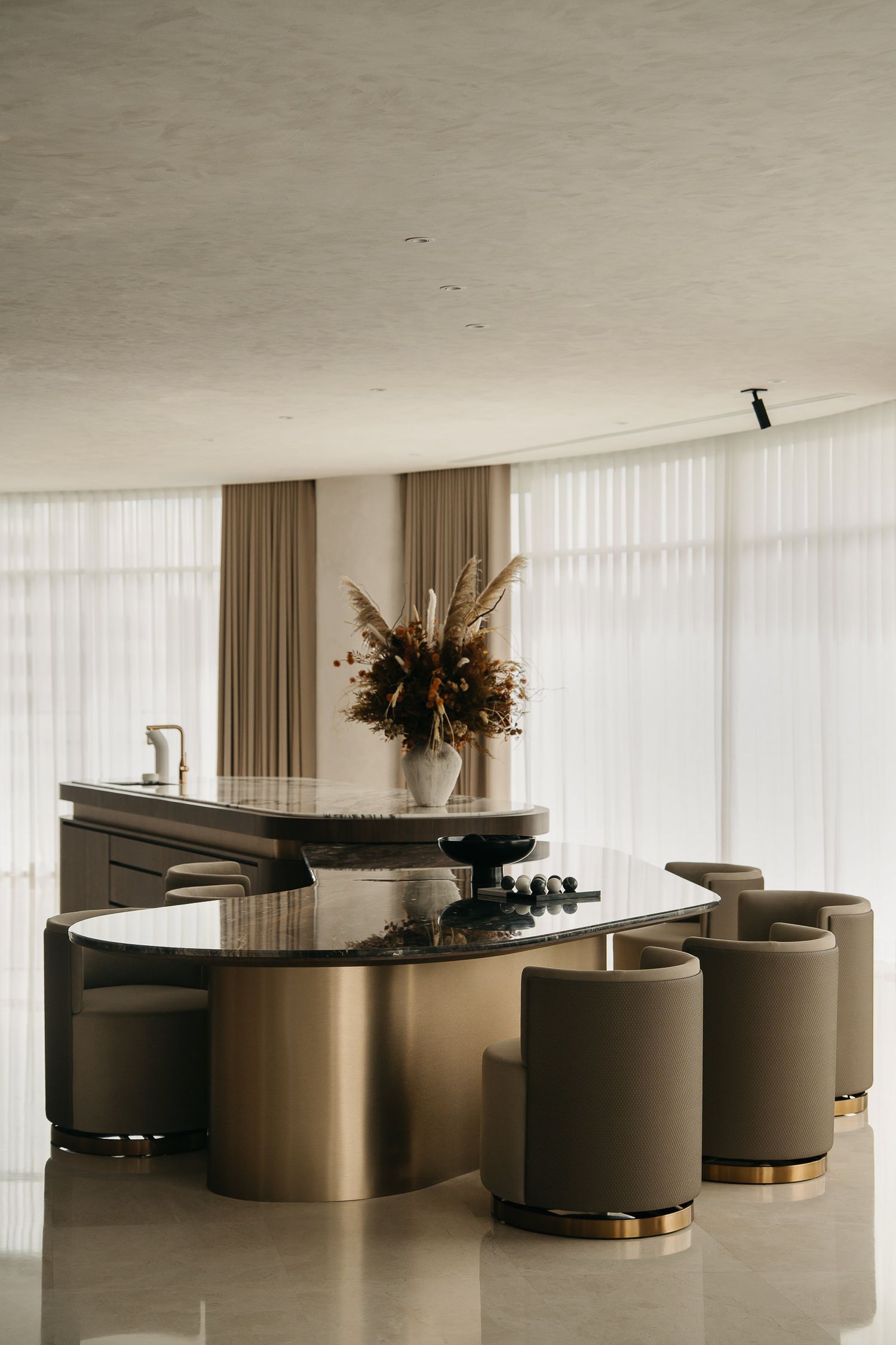 Modern luxury lounge area with curved velvet seating and grand piano arranged around a circular design.