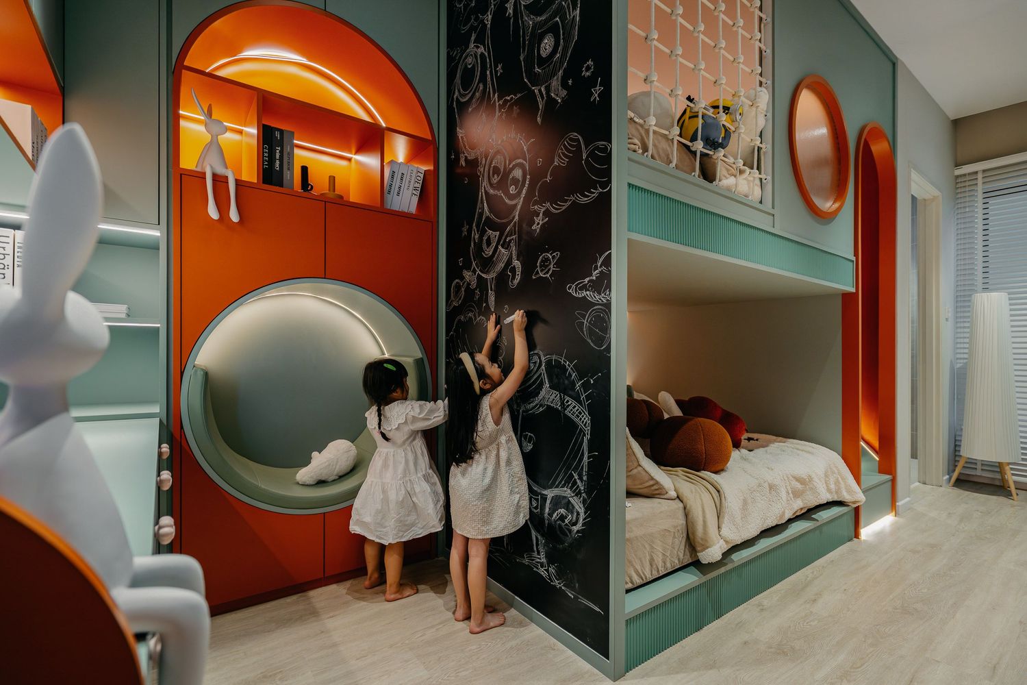 Whimsical children's room with orange circular portal design and bunk bed configuration.