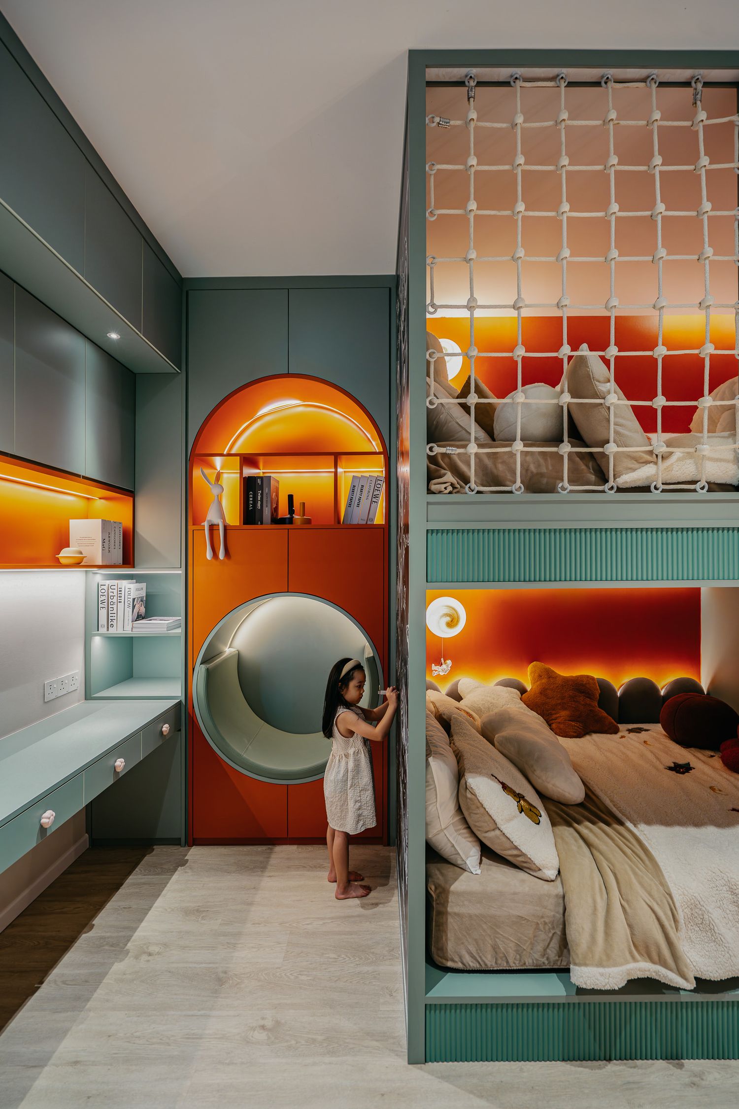 Modern children's bedroom featuring a built-in bunk bed with orange arched details and sage green walls.