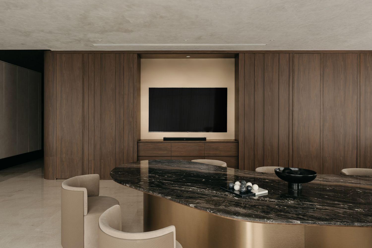 Modern minimalist interior with dark marble surfaces and wooden wall panels creates a luxurious atmosphere.