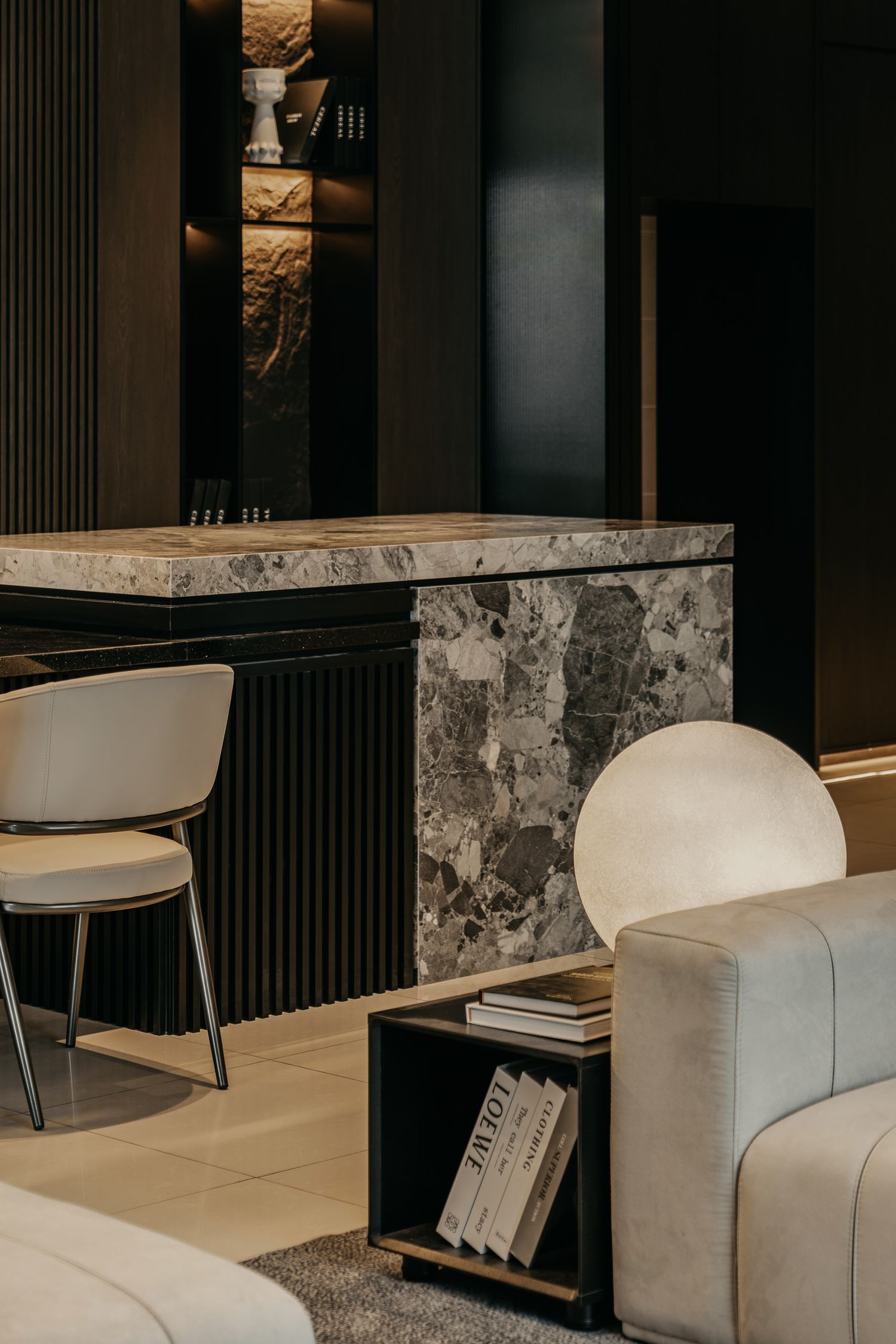 Luxurious interior featuring marble countertop and modern furniture with dark accent walls.