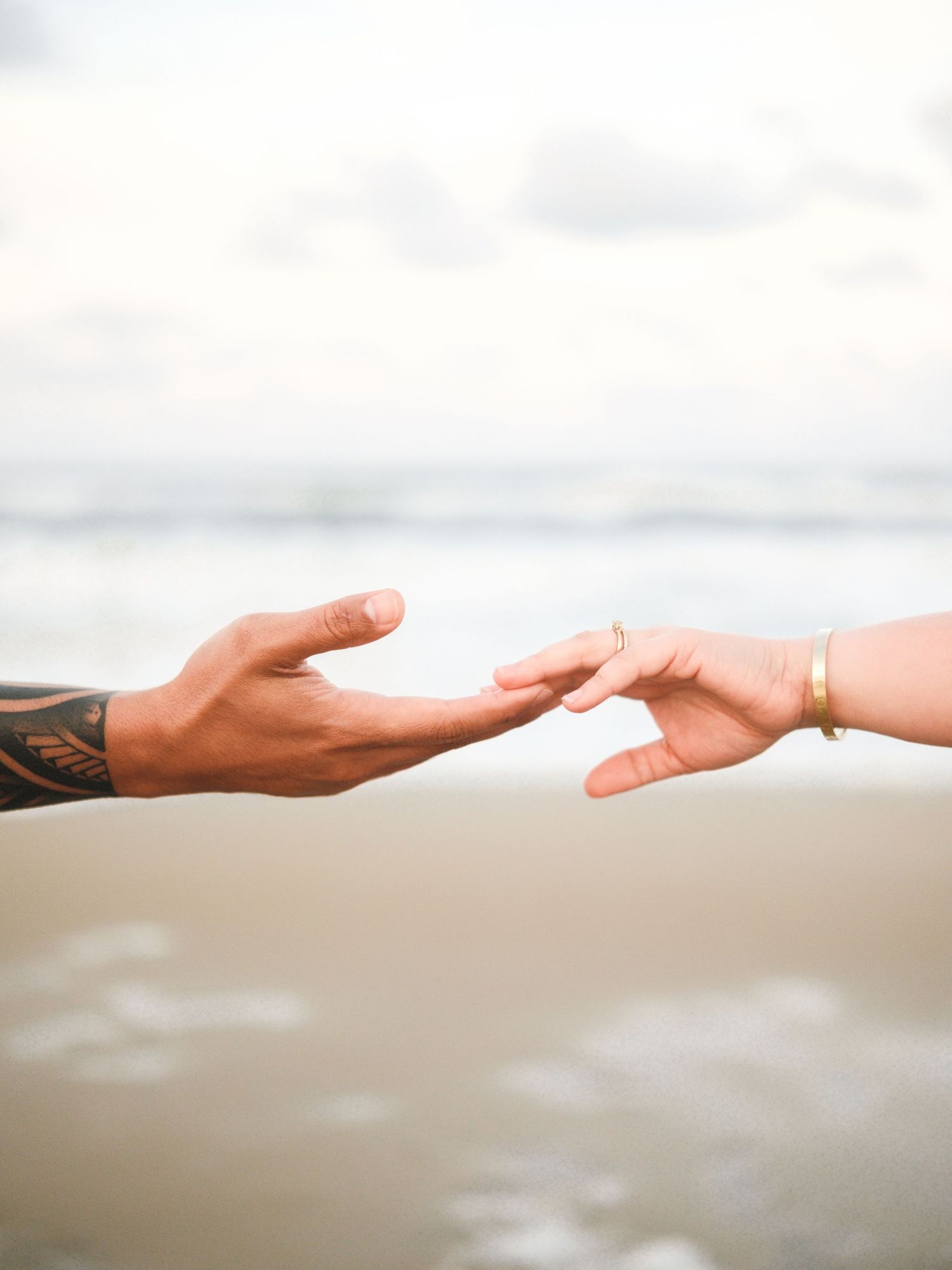 Multiple hands reaching out and touching in a sequence against a bright white background, symbolizing unity and connection.