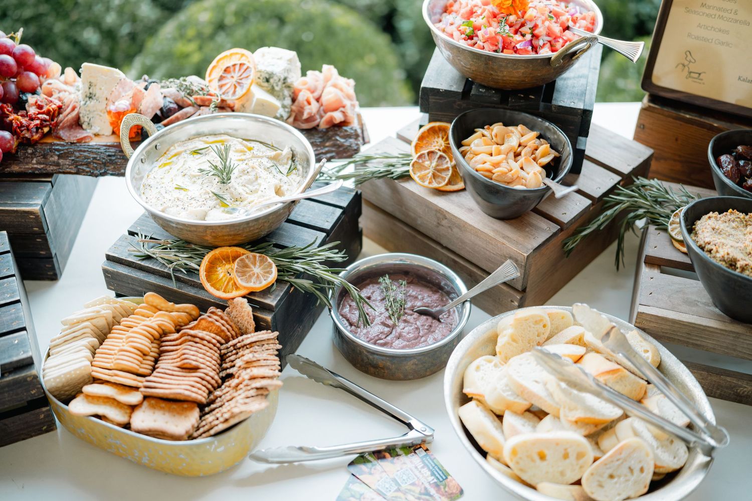 Various party appetizers and snacks displayed on plates and platters at a buffet-style gathering.