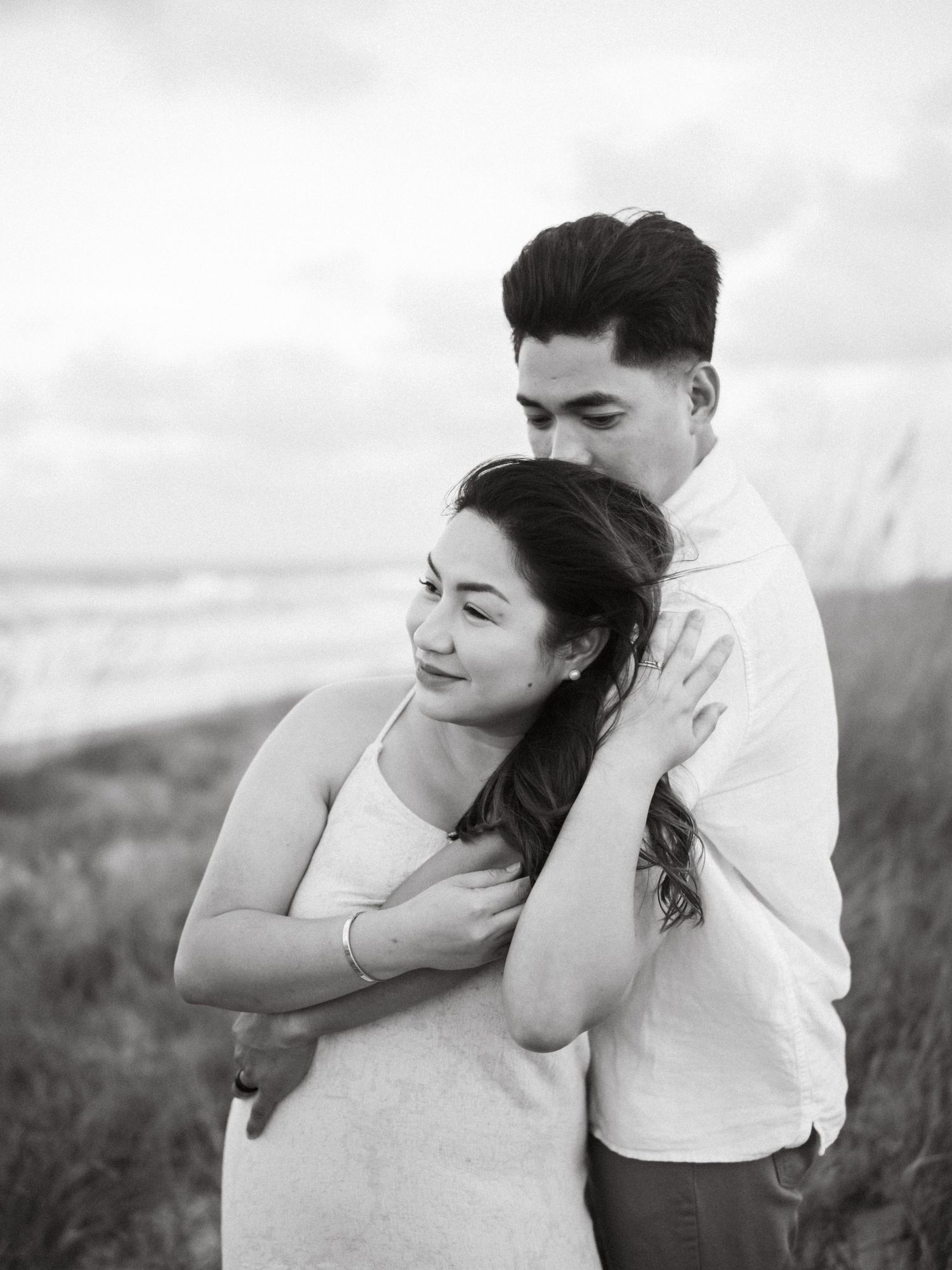 A romantic black and white photo sequence showing tender expressions between a couple in casual attire.