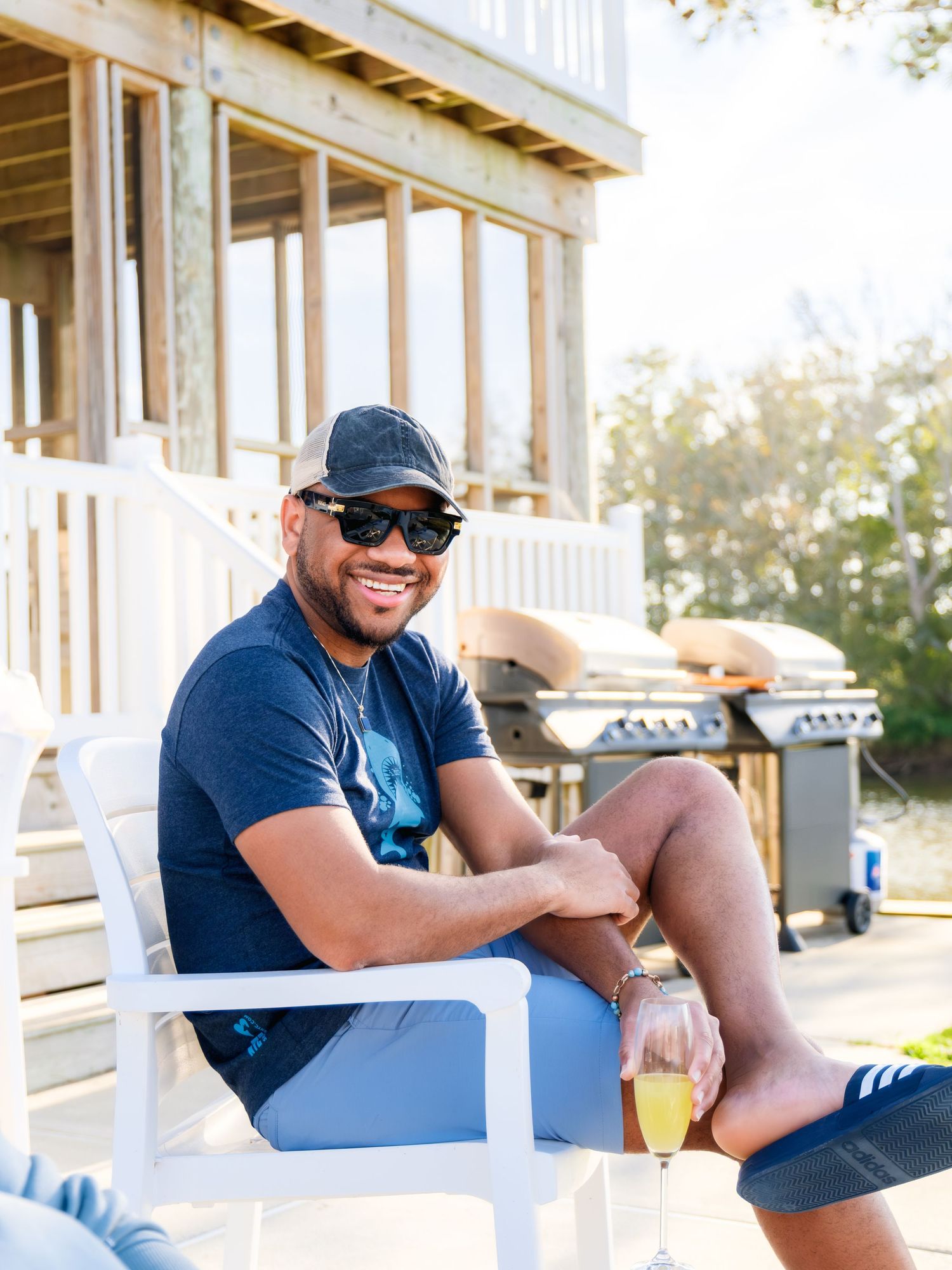 Three candid photos show a person relaxing and smiling on a white porch in casual summer attire.