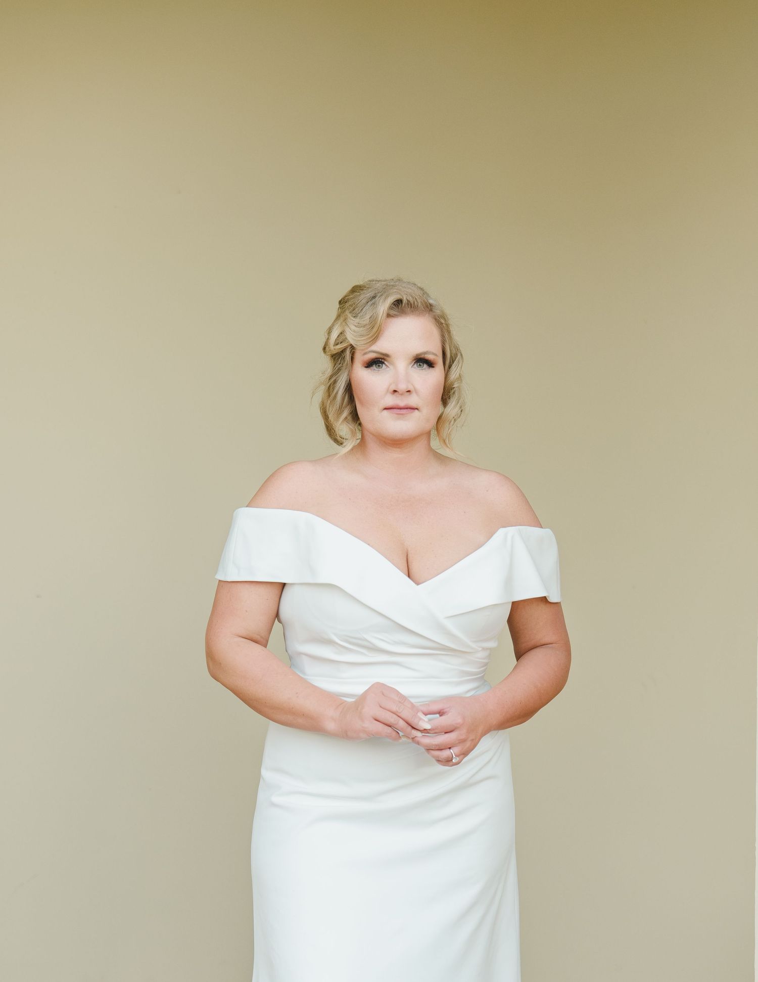 A sequence of bride portraits in a white off-shoulder wedding dress against a neutral beige backdrop.