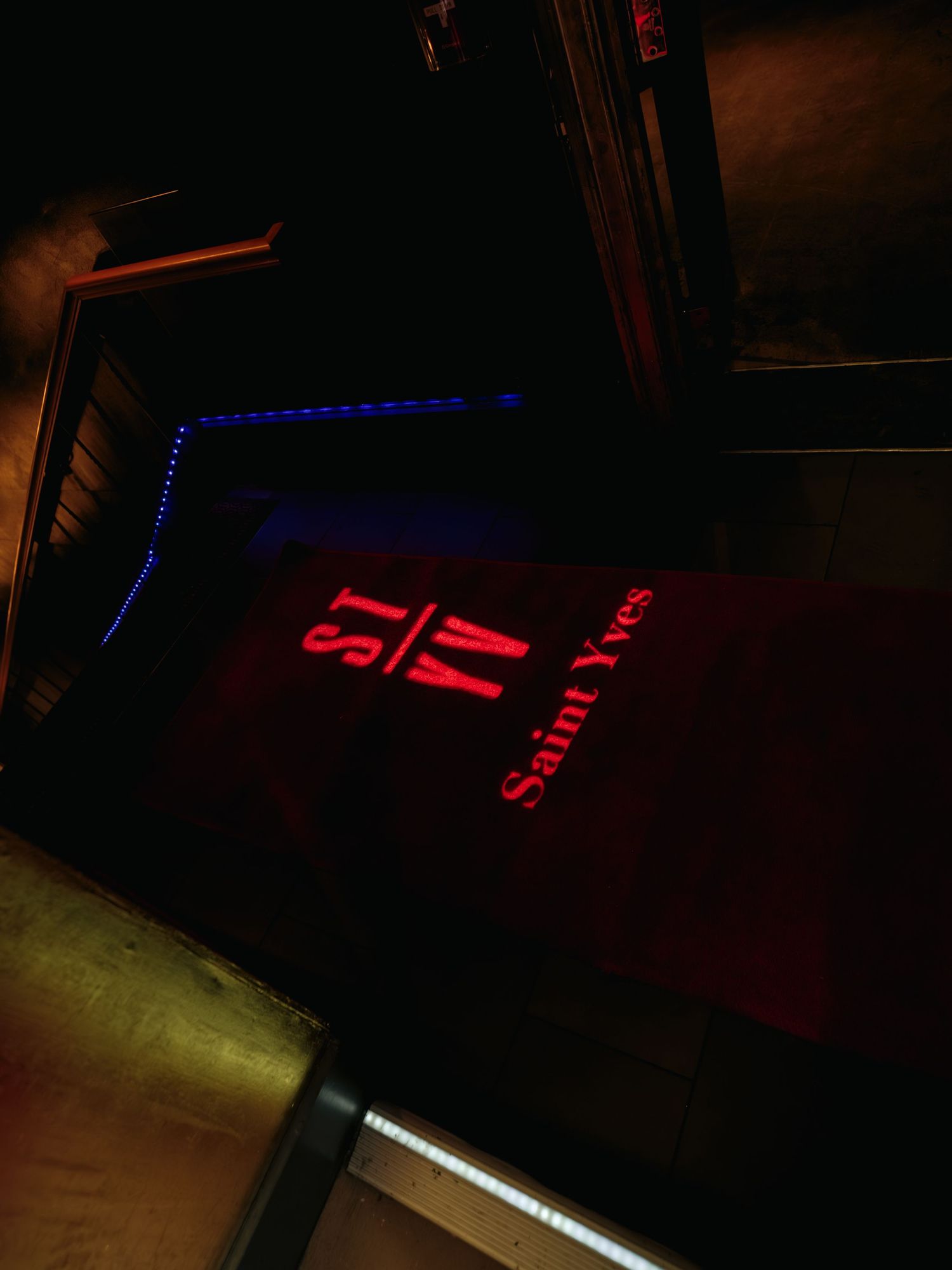 Dimly lit room with red and blue LED lighting creating a moody atmospheric ambiance.
