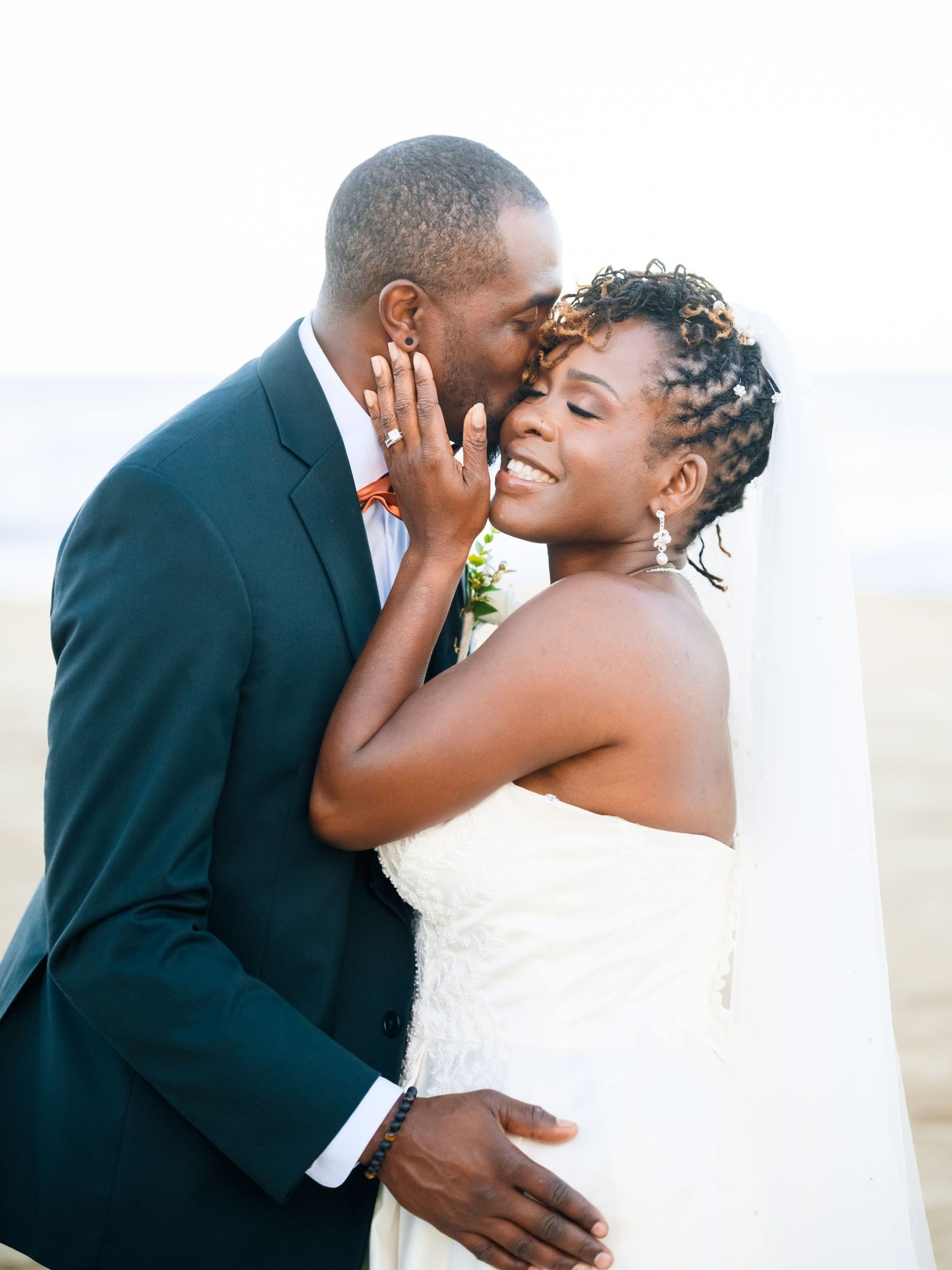 Romantic wedding couple shares intimate moments in a series of tender beach portraits.