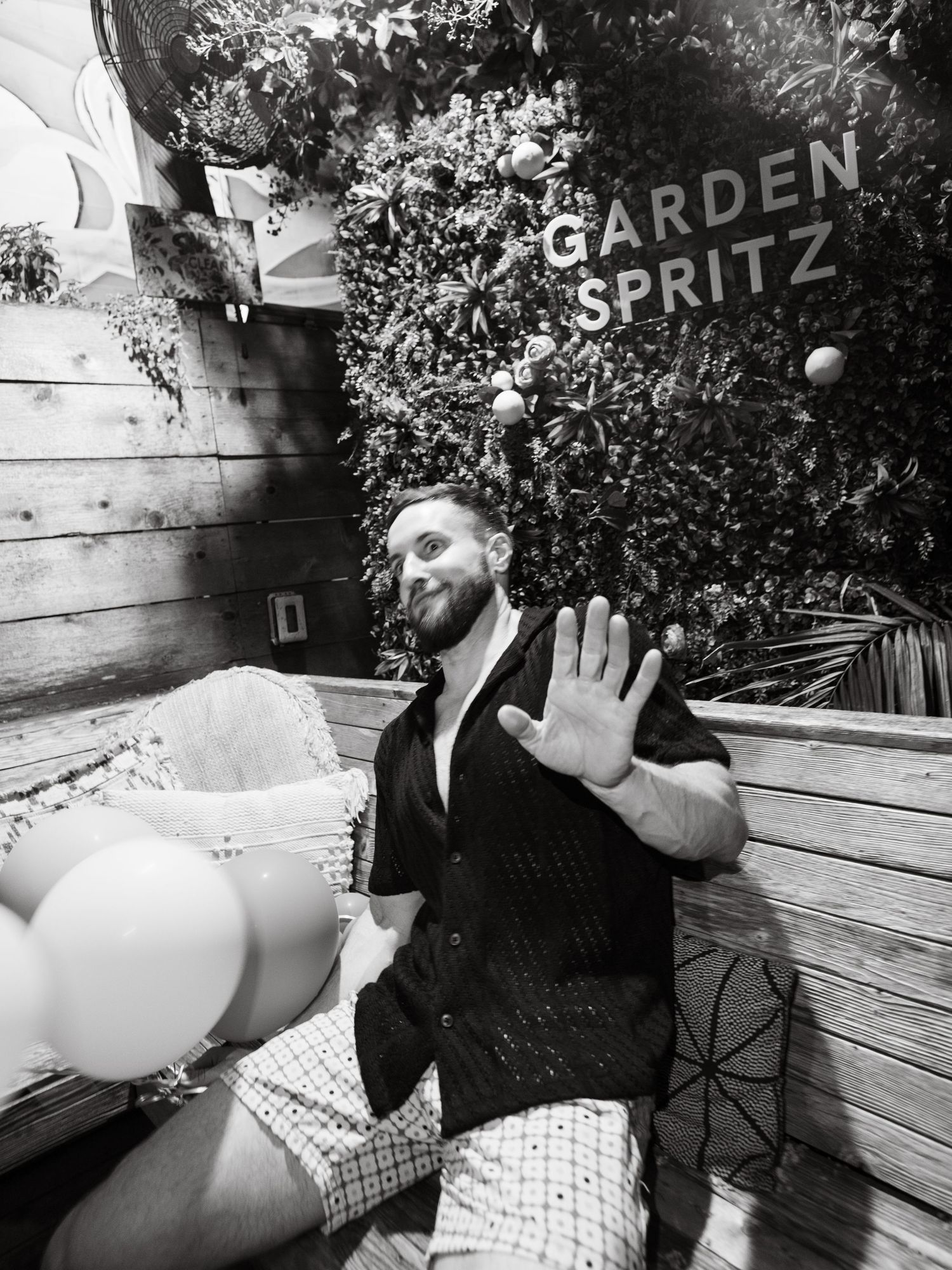 Black and white photo collage showing candid moments of someone sitting on wooden benches in an outdoor garden setting.