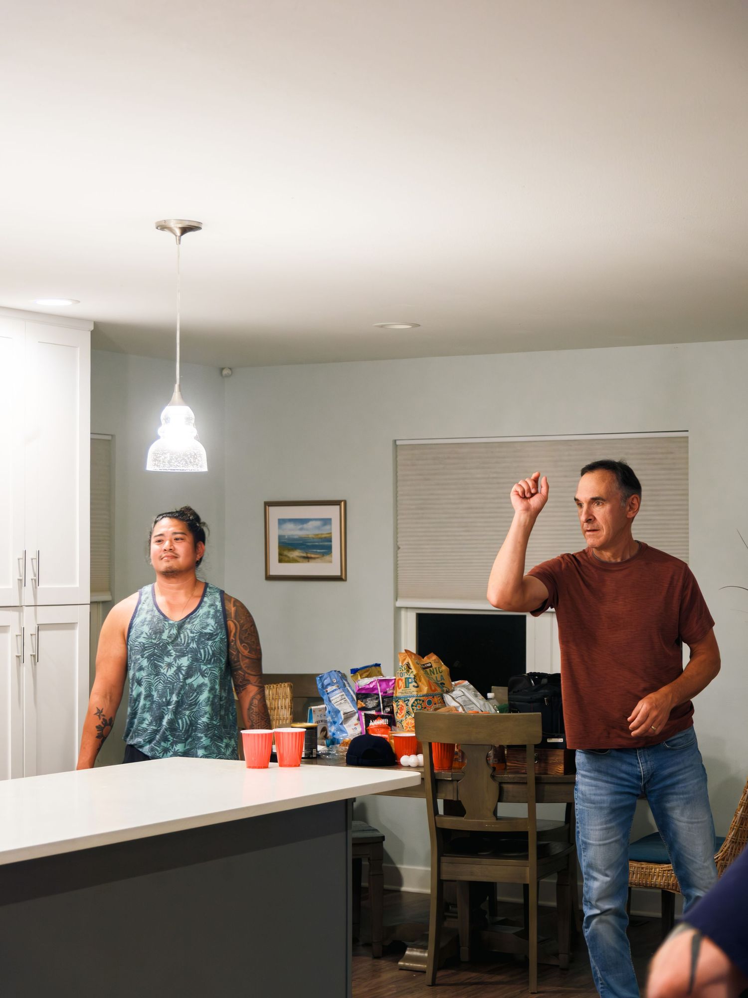 A sequence of photos showing someone opening kitchen cabinet doors while looking into them.