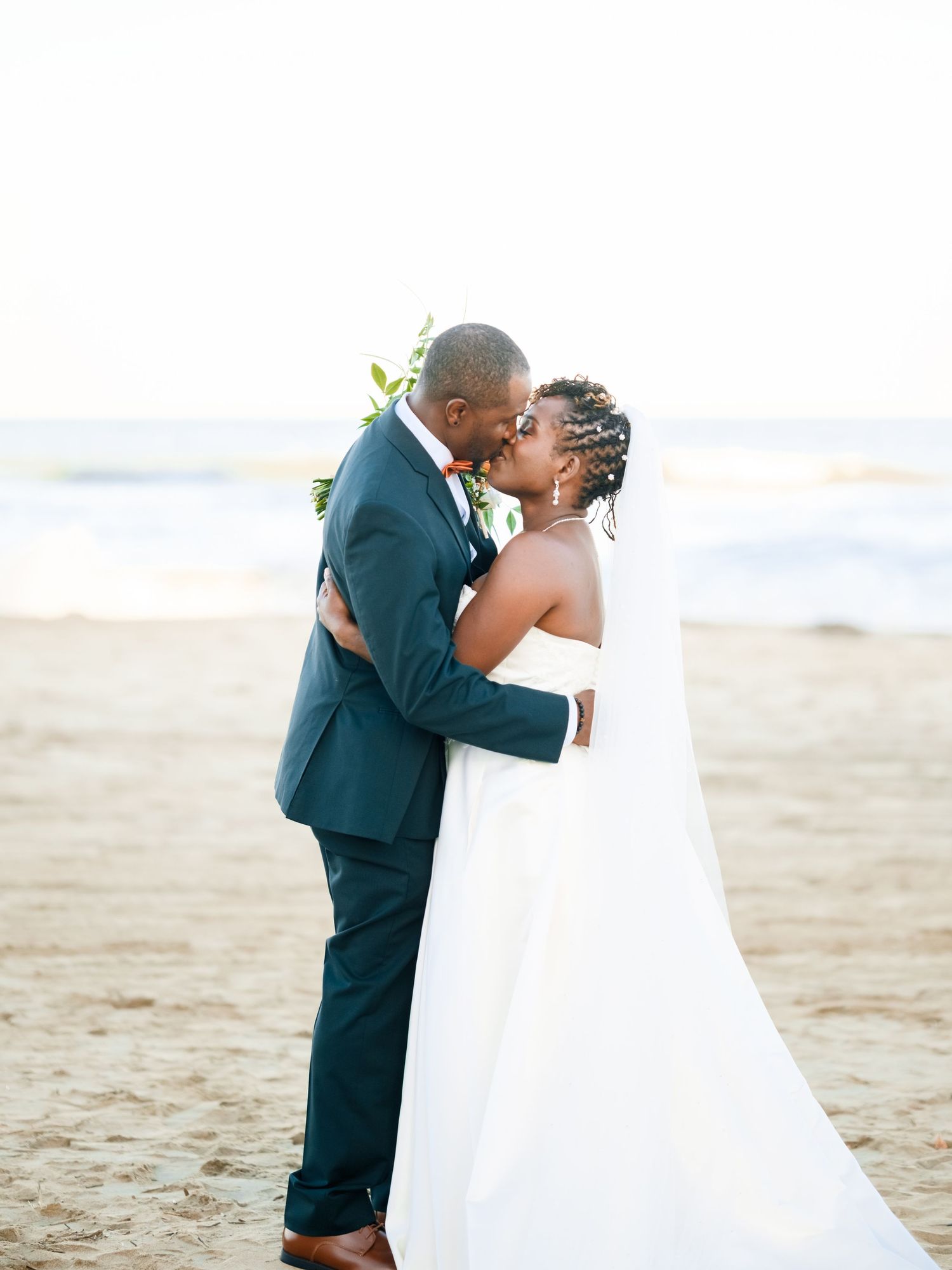 Intimate beachside wedding portraits showing tender moments between the couple.