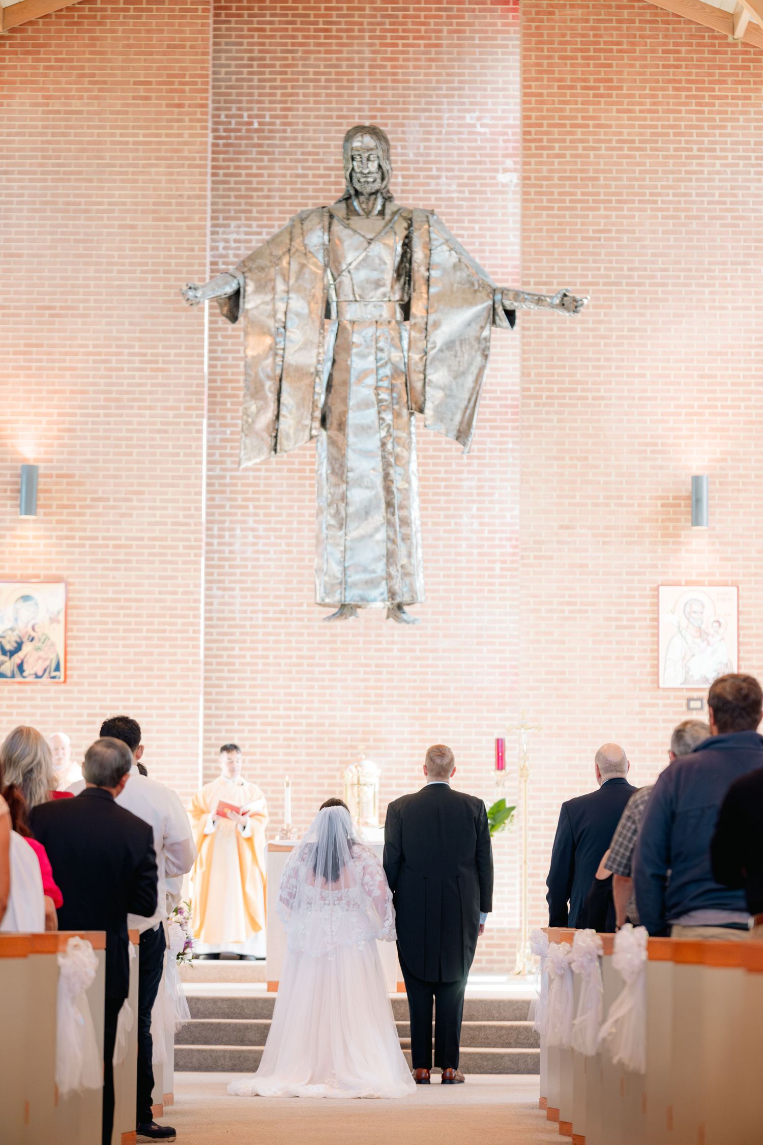 Wedding ceremony featuring multiple photos of attendees gathered in a church with brick walls and a white-clad figure.