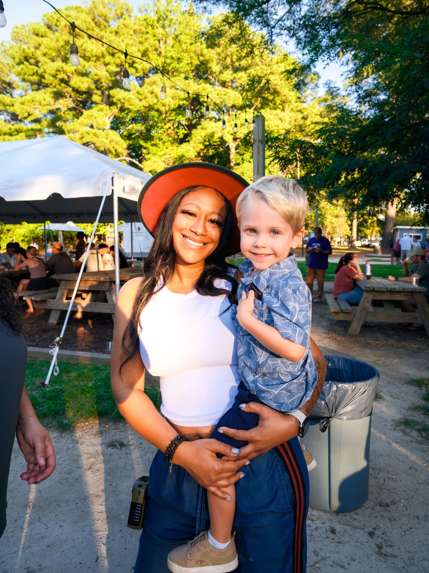 A wonderful outdoor moment captured at a summer festival with trees in the background.