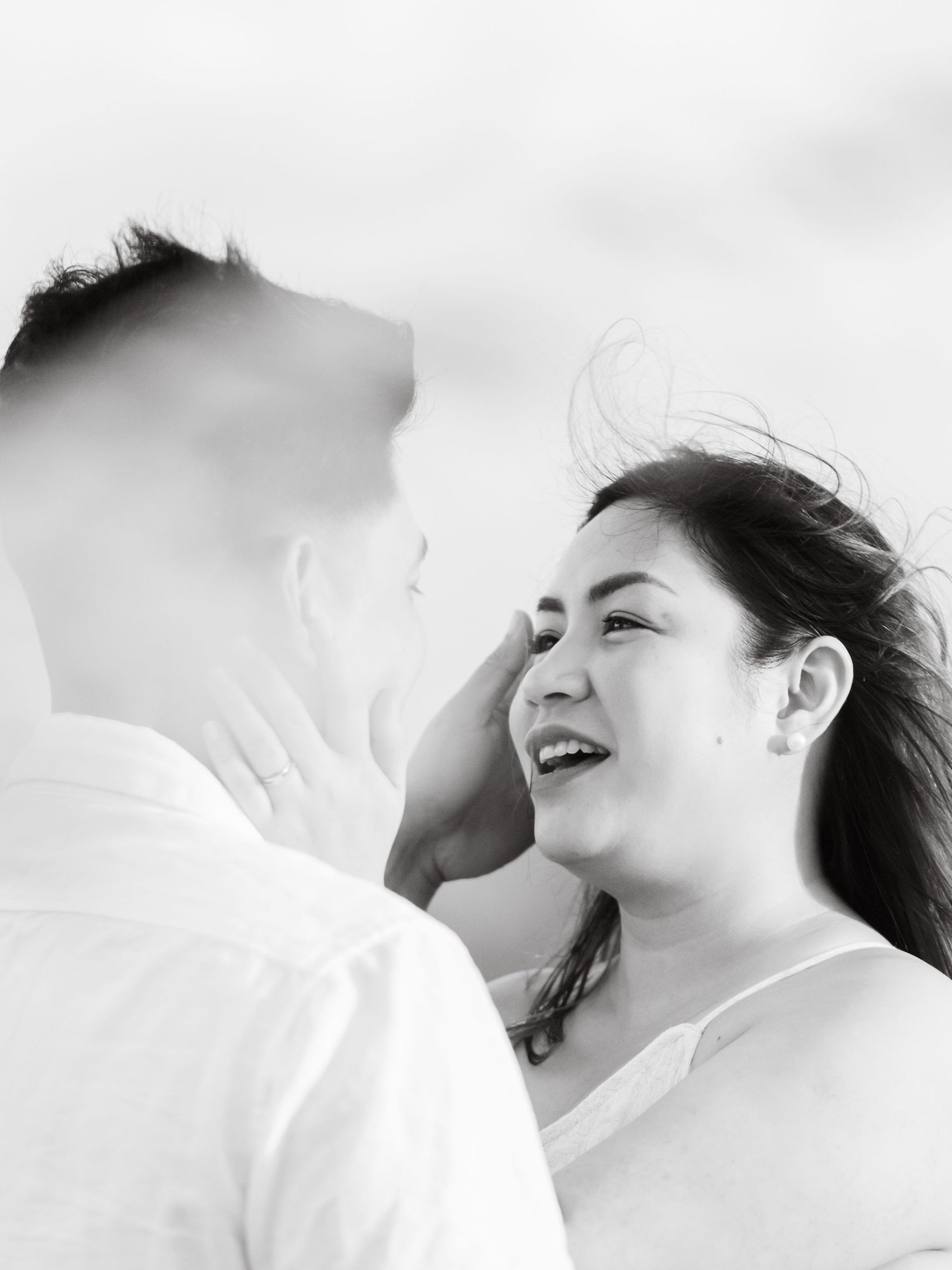 Black and white high contrast photo sequence showing joy and laughter in a playful intimate moment.